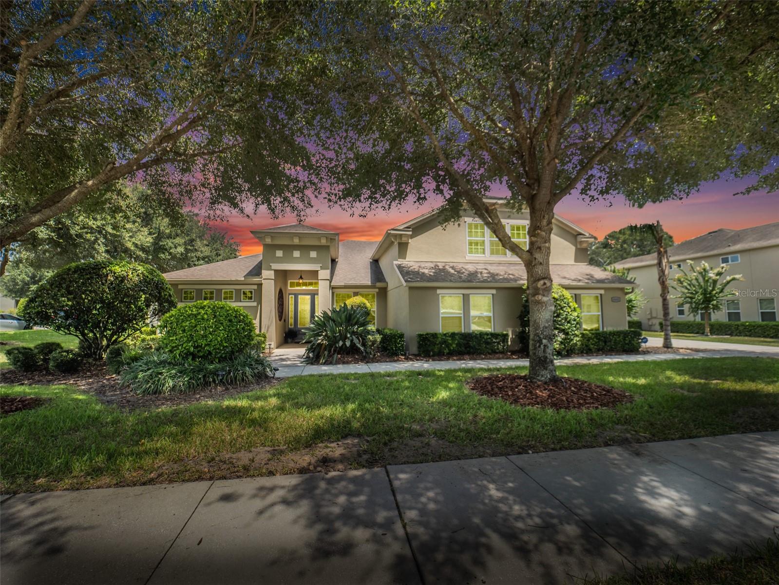 Experience this stunning former model home, perfectly situated on an oversized corner lot in a gated community with picturesque, mature tree-lined streets. This spacious residence offers 5 bedrooms, 4 full bathrooms, a dedicated office, and an expansive upstairs bonus room—ideal for multigenerational living or flexible work and play spaces. The chef’s dream kitchen is beautifully appointed and opens seamlessly to the light-filled family room, creating the perfect setting for everyday living and entertaining. Soaring ceilings and an abundance of natural light flood the home, highlighting the professionally designed and impeccably maintained interiors. Step outside to enjoy a newly added pool and large covered lanai, ideal for year-round gatherings. The privacy-fenced backyard is surrounded by lush, manicured landscaping offering both beauty and seclusion. The home's triple-split floor plan provides privacy and functionality, with 4 bedrooms, 3 baths, and an office located downstairs, while the upstairs retreat features a spacious bonus room, full bedroom, and bathroom—perfect for guests or extended family. The oversized 3-car, side-entry garage offers ample storage and convenience, while the inside laundry/utility room adds to the thoughtful layout. This former model is loaded with every upgrade and luxury feature imaginable, making it truly move-in ready and one-of-a-kind. Conveniently located to shopping, restaurants, 429, I-4 and nearby professional services. Perfect location!