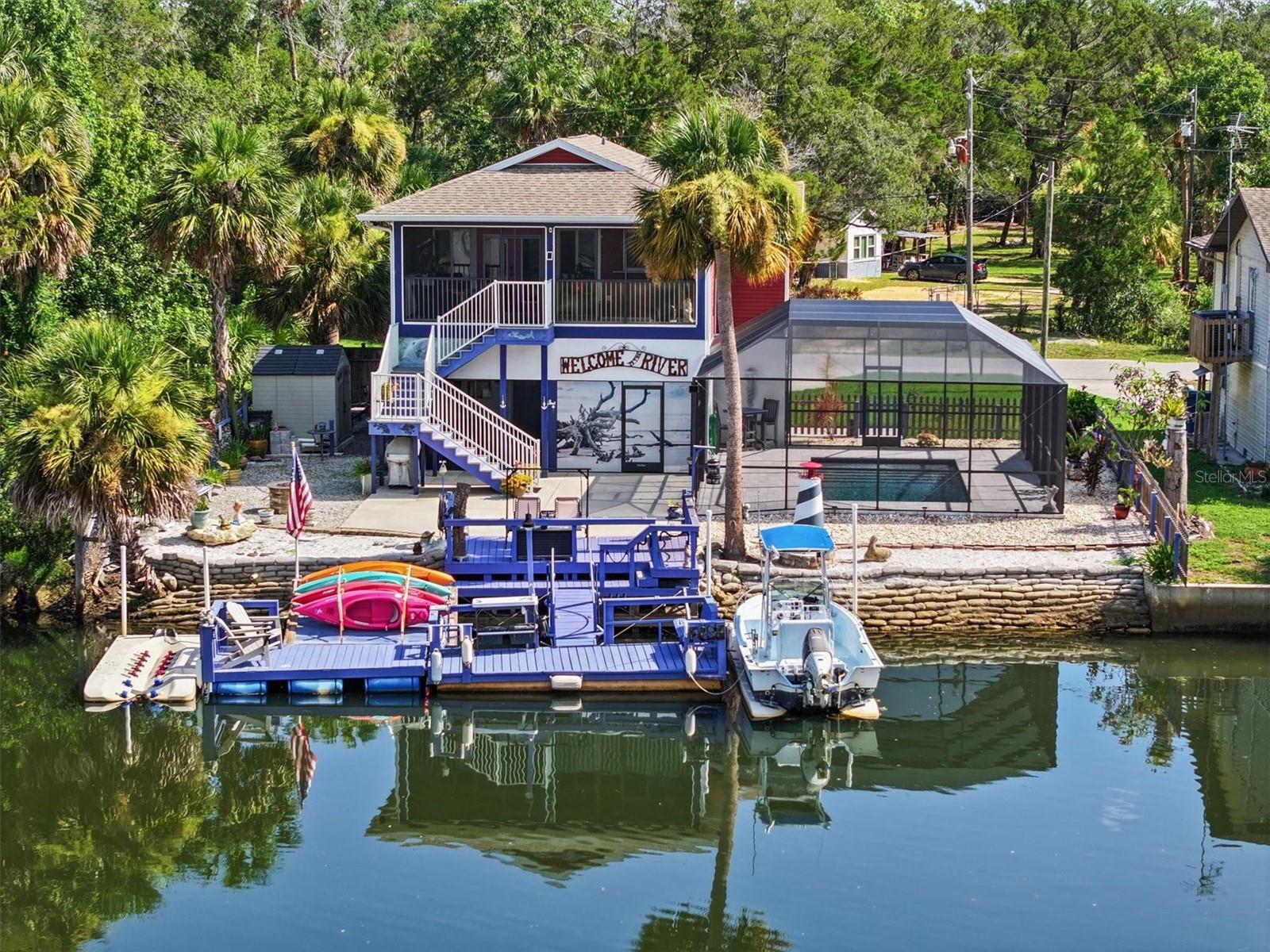 Direct Gulf Access Turnkey Stilt Pool Home with Drive-On Boat Docks in Palm Grove Colony!
Live the ultimate Florida boating lifestyle in this fully furnished, turnkey 2-bedroom, 2-bathroom stilt home with a heated/cooled in-ground pool, elevator, and TWO drive-on boat docks, all set along 70 feet of prime saltwater canal frontage leading directly to the Gulf—no fixed bridges and just minutes via the Mud River! Bring your boat, kayak, RV, and fishing poles—no HOA, no restrictions, and short-term rentals are allowed.
Watch dolphins and manatees cruise behind your home while you catch redfish, snook, and snapper right from your private backyard oasis. Enjoy the screened rear porch overlooking the canal, or dive into the pool after a day on the water.
Inside, this elevated home blends modern comforts with laid-back coastal style:
Open floor plan with vaulted ceilings
Luxury vinyl plank flooring
Granite countertops & stainless steel appliances
Washer & dryer included
Whole house generator for peace of mind
Garage-level bedroom & bath, plus outdoor shed
RV hookup with electrical & sewer cap
Floating dock for additional access to the water
What truly sets this property apart is its location in Palm Grove Colony—a hidden gem community just 60 minutes north of Tampa. This quiet, spring-fed enclave sits off the beaten path, tucked away from the traffic of US 19 and SR 50. Residents enjoy exclusive access to Little Salt Spring, a community-owned freshwater spring ideal for swimming, paddleboarding, or simply unwinding in nature’s beauty.
Nestled along the 3-mile-long Mud River, which joins the Weeki Wachee River before meeting the Gulf, the area is renowned for boating, scalloping, diving, snorkeling, and intimate manatee encounters. This is classic Old Florida—no stress, just water, wildlife, and wonder.
Whether you're seeking a full-time residence, vacation retreat, or income-producing rental, this home checks all the boxes. And thanks to its elevated stilt design, even past flooding events have been minimal—an inconvenience rather than a disaster, with only the garage affected and the main living area untouched. The home comes turn key with furniture, home goods, and decorations minus a few personal items the owner wants to retain.
Come experience the magic of Palm Grove Colony—a place where the river flows freely, nature surrounds you, and the Gulf is always calling.