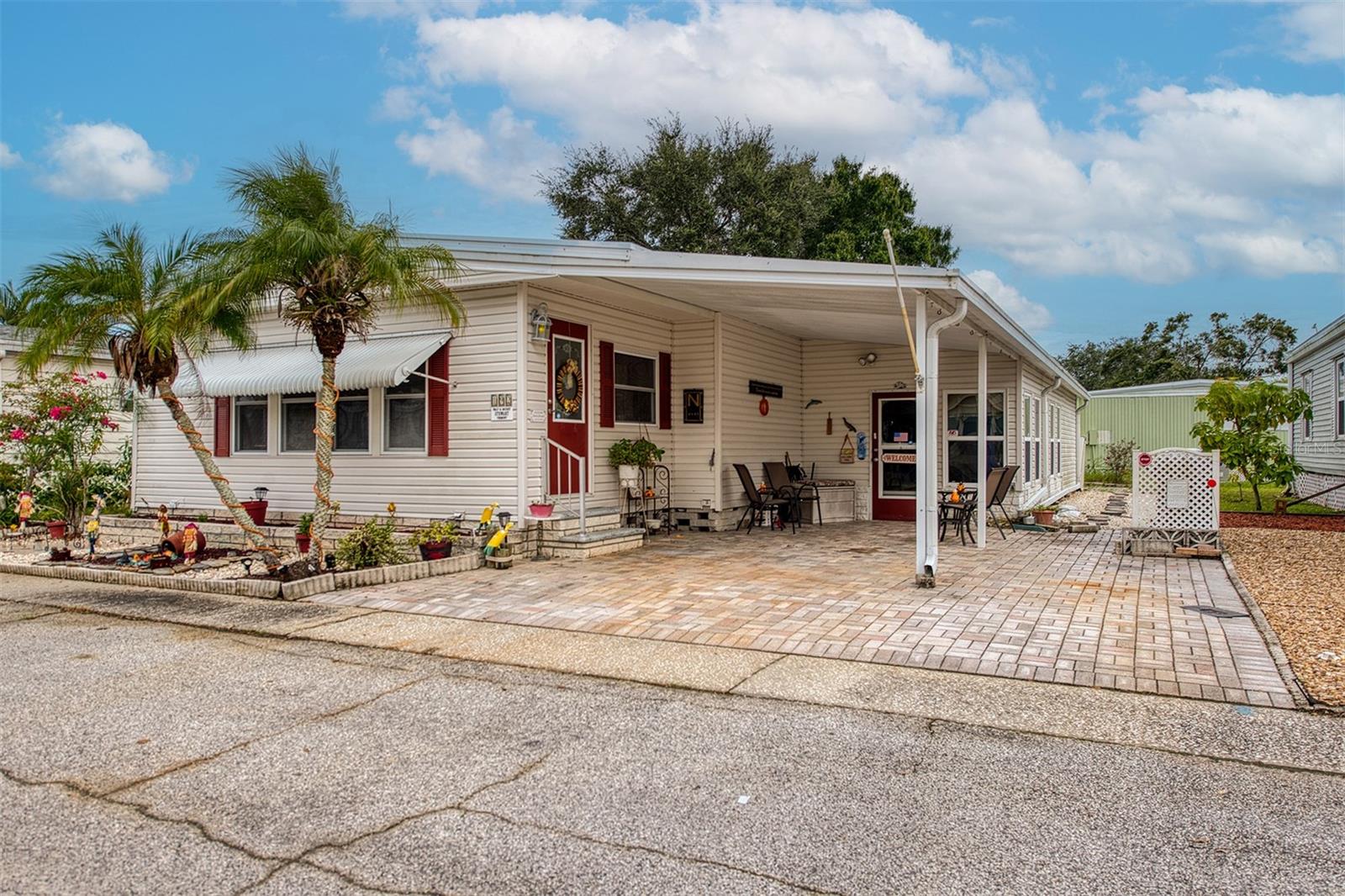Just listed in the highly sought-after Gull-Aire Village-enjoy peace and quiet in this prime location! This spacious home offers 1,274 square feet of comfortable living space, complemented by a beautiful two hundred square-foot air-conditioned Florida room, perfect for relaxing or entertaining. You are just a short stroll from the community pool and clubhouse. The home features sturdy plywood subfloors with laminate flooring throughout. Major updates include an A/C and water heater installed in 2023, ensuring year-round comfort. Updated windows and siding. Roof-over. Washer and Dryer are in the utility room. Pavers on driveway and parking pad. Gull-Aire Village is known for its vibrant social scene. The clubhouse hosts monthly planned activities and includes amenities such a pool table, shuffleboard, bocce ball court, and a heated pool and spa. Stay active with regular yoga, pool exercise, bingo, cards, and line dancing. The neighborhood is also golf cart friendly! HOA fees are just $60 per month. The community is pet friendly-you can have one pet of any size, and a second pet is allowed with a doctor's letter for emotional support. Best of all, you own your land. Convenience is at your doorstep. Across the street from the community, you will find AMC Theatres, Bealls, Marshalls, PetSmart, Five Below, and Dollar Store, along with popular dining spots like Shaker & Peel, Craft Street Kitchen, Mandola's, Country Pizza Italian Grill, and Eve's Family Restaurant. Super Walmart, Publix, and Countryside Hospital are only minutes away. Love the outdoors? The beautiful beaches of Honeymoon Island and Caladesi State Park are about ten miles away, and there is a scenic biking and walking trail along the canal with access points from the community. Room sizes are approximate. Do not miss this opportunity to live in one of Oldsmar's most desirable communities!