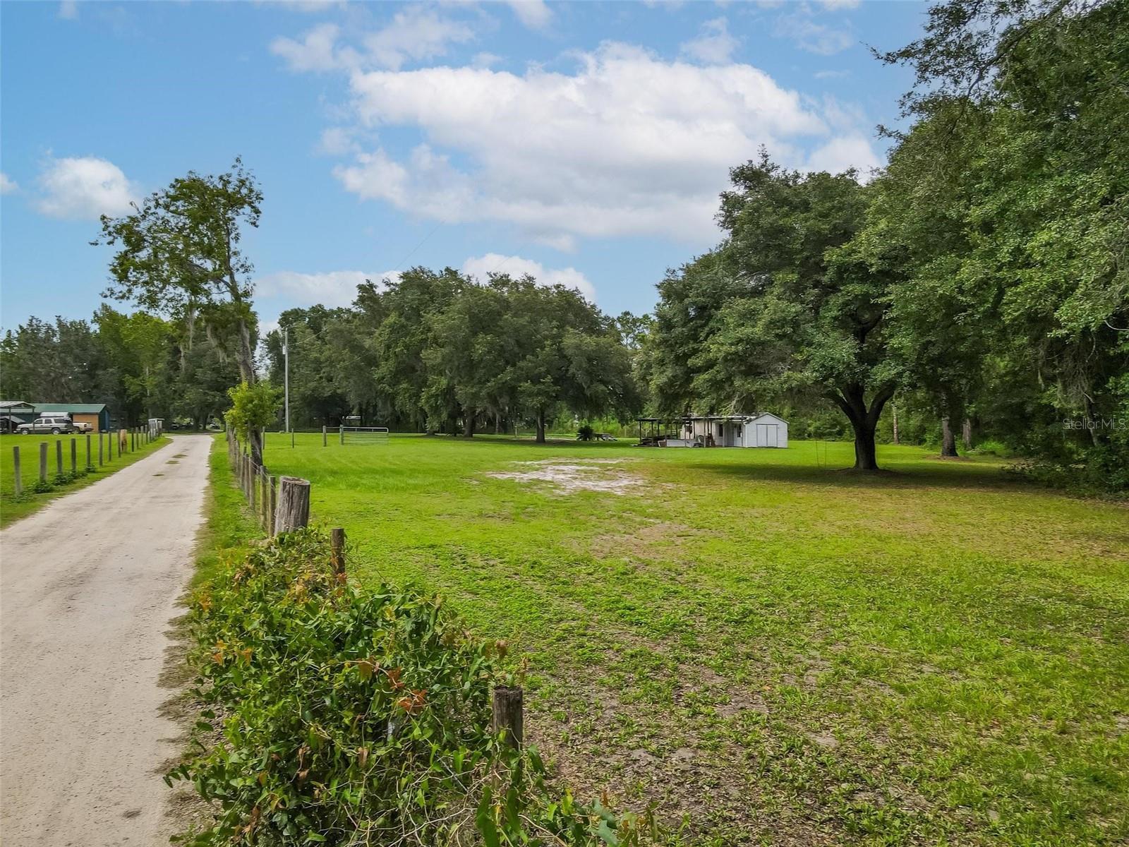 COUNTY WILL ALLOW 2 HOMES TO BE BUILT. Beautiful PRIME LOT in GREAT LOCATION. READY TO BUILD YOUR DREAM HOME.
Property has a WELL, SEPTIC and ELECTRICAL CONNECTED. ALL HIGH, DRY, FLAT, FENCED AND CROSS FENCED. Utility shed and Carport. Land comes with an IMPACT FEE CREDIT. Single family home, Modular home or Manufactured Homes are ok. Animals Okay. NO HOA. Country Living but close to shopping. just minutes to Publix, Under an hour to all major attractions and downtown Orlando. ABSOLUTELY NO VERBAL OFFERS.