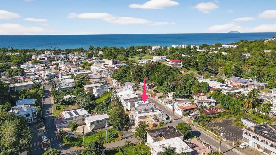 Imagine a charming two-story vacation getaway located just 200 meters from the vibrant town center of Rincon and 700 meters to the beach. The property features a cozy front porch, perfect for relaxing on sunny afternoons. Upstairs you have an open layout with the living room and kitchen combined plus 1 bathroom and 1 bedroom. Head outside and take the exterior stairs down to a beautiful oasis complete with an in ground pool. Just off the pool is the larger of the two units. As you walk in you are greeted with the breakfast nook over looking the pool and built in desk on your left. Straight ahead you'll find the compact, fully functional kitchen and the bathroom to the left. If you head up the half stairs you'll find the loft style living room and private bedroom to the right. This turnkey property includes a solar hot water heater, a cistern for back up water and parking for 2 cars. This is the perfect investment property for any beach lover that is looking for rental income and a place that is close to everything!