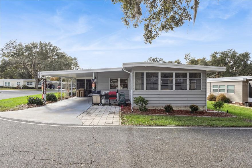 *AFFORDABLE FLORIDA LIFESTYLE*BEAUTIFUL SETTING*BIG CLUBHOUSE WITH LOTS OF ACTIVITIES* You'll appreciate this will-maintained, move-in ready home on a nice corner lot. Step into the nice big Florida room with windows all around. You'll spend many hours here reading, doing hobbies and watching the world go by. The living room is very large with lots of light and continues to the dining room. Dining room features a built-in buffet wall for great storage. New hard surface flooring installed in 2024 goes throughout the house, for easy care. 2 big pantries in the kitchen let you store lots of goodies. The kitchen has a 2024 dishwasher and an access door to the carport for convenience and it also goes to the heated laundry/workshop/storage room. Bedroom 2 is a good size that will handle a king size bed, has built-in drawers and a walk-in closet. A bath with tub/shower combo, vanity and large built-in linen cupboard is across the hall. Both baths have new tall commodes in 2024. At the end of the hall you'll find the primary bedroom. It has good incoming light, room for a king size bed, built-in drawers and attached bath with long vanity, walk-in closet, and step-in shower. Other updates include: hot water heater 2025, irrigation system, electric panel box and wiring for hot tub with surge protector 2024, carpet in Florida room, lanai and ramp, extra bright bath lights, roof coated in 2025 for additional life and screen for rain gutters. ALL YOU HAVE TO DO IS MOVE RIGHT IN! You'll fall in love with the 55+, Hawthorne community with big trees and an old south feeling. A large clubhouse features a hospitality lounge, card and craft room, billiard room, fitness center, library and more than 100 activities and friendly folks. Pickleball, tennis and outdoor activities abound. There are pools and walking trails and a marina with direct access to the Harris Chain of Lakes. Hawthorne has a state-of-the-art emergency response system with 3 emergency vehicles and 24/7 firefighter/EMTs. Homes are equipped with emergency alarm buttons. Monthly fee includes 24 hour gate security, basic cable, community pool, ground maintenance, manager, sewer and water. Location is convenient to shopping, dining, banks, groceries, major highways and attractions. THIS IS THE AFFORDABLE, LIFESTYLE YOU'VE BEEN SEARCHING FOR!!!