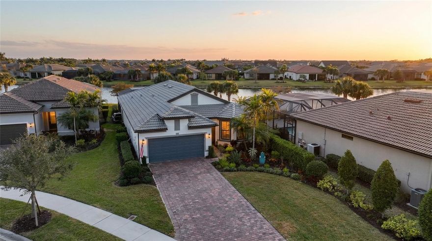 Experience Florida living at its finest at this gorgeous home in the highly sought-after, resort-style community of IslandWalk in Venice. This beautifully appointed three-bedroom, two-bath FULLY FURNISHED residence offers an exceptional blend of elegance, comfort, and breathtaking natural beauty. Thoughtfully designed, built, and maintained by it's original owners for effortless living and entertaining. The home features an open, light-filled floor plan with spacious living areas that flow seamlessly to the outdoor retreat. Ideally positioned on a desirable eyebrow homesite. It’s long driveway is set back from the main road, offering enhanced privacy, minimal traffic, and a more peaceful setting. A screened front entryway creates a welcome first impression while allowing for refreshing cross breezes. The well appointed kitchen has beautiful granite countertops, stainless steel appliances, an expansive island with seating, end cap storage on both ends of the island, and a walk in pantry. The formal dining area overlooks the lanai and offers lovely lake views. The primary suite offers a beautiful view of the lake and leads to your ensuite bathroom. The gorgeous bathroom features dual sinks, a walk in shower, a separate soaking tub, and an oversized, custom built walk in closet with plenty of added shelving. The two guest bedrooms and bath are on the opposite side of the home, allowing privacy for your guests. Step outside to your spectacular outdoor retreat! A very large covered lanai provides expansive shaded space for lounging and entertaining, creating the perfect setting for year-round Florida living. Enjoy soaking in your heated saltwater pool and spa, where you’ll enjoy gorgeous, long lake views and stunning sunsets with the desirable southeastern exposure. The lanai is also plumbed for an outdoor kitchen, offering the opportunity to design the ultimate alfresco entertaining space. The oversized 2.5 car garage has an epoxy floor and plenty of room for a workshop for your hobbies, as well as room for your golf cart! There is even a utility sink in the garage for easy clean up. The full home generator stays! Other features include:  full hurricane protection (front door is hurricane rated), 8' doors, plantation shutters throughout, tile flooring, oversized interior laundry room with added storage, pull down attic steps have been added with insulation and plywood flooring installed for useable attic storage. The HOA fee covers lawn care, irrigation, amenity access, and a cable/internet package including 3 boxes. Located within one of Venice’s premier gated communities, residents enjoy access to world-class amenities in a golf cart friendly community, including 2 clubhouses, 2 fitness centers, geothermal resort-style pools & spas, a lap pool, tennis, pickleball, and bocce courts, walking trails, playground, dog park, and a full calendar of social activities. IslandWalk has very low CDD fees. All just minutes from Gulf beaches, dining, shopping, Wellen Park, and CoolToday Park, home of the Atlanta Braves spring training!