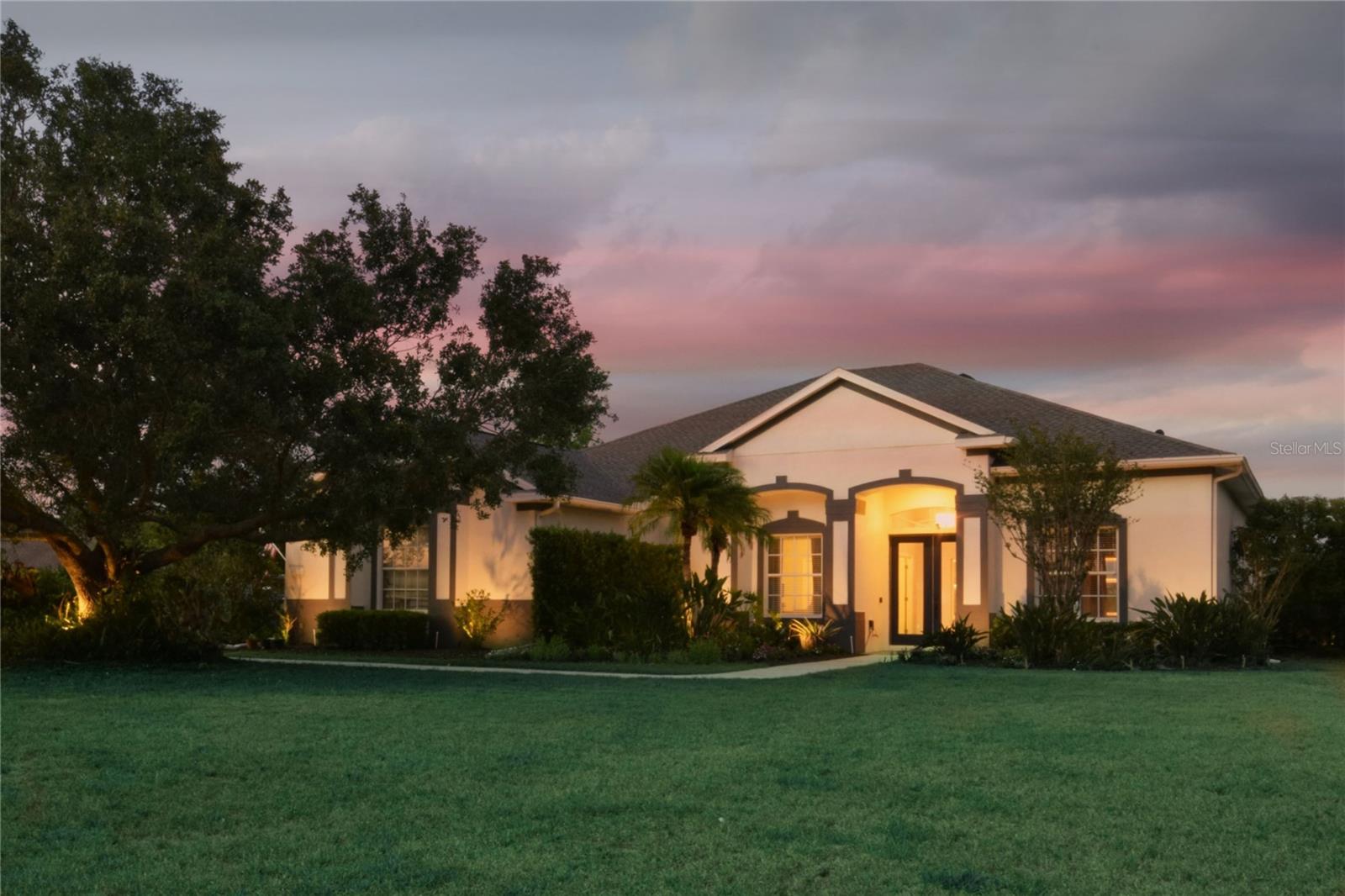 Welcome to 8121 Snowy Egret Place, a luxurious 5-bedroom, 3-bathroom estate set on a private, uniquely shaped 1.18-acre lot in one of Bradenton’s most picturesque and family-oriented communities. Surrounded by lush greenery, open skies, and starry nights, this impeccably maintained property blends spacious indoor living with world-class outdoor amenities—all while embracing Florida’s natural charm.
Step inside to find soaring ceilings, freshly painted interiors, and luxury vinyl plank flooring flowing seamlessly throughout. A flexible fifth bedroom with French doors provides the perfect space for a home office, den, or guest suite.
At the heart of the home is a generously large kitchen that flows into expansive living and dining spaces before opening to your showstopping 30'x25' covered lanai—an entertainer’s paradise and the perfect way to enjoy Florida’s incredible weather and scenery. This outdoor living area boasts a fully-equipped kitchen including ample bar-top seating with a stainless grill, vented hood, wet bar, refrigerator, and plenty of cabinetry—all laid over travertine stone tile. The lanai also features multiple ceiling fans, recessed lighting, and separate dining and lounging areas, making it ideal for both gatherings and peaceful mornings with coffee or tea.
Just beyond, the resort-style pool beckons with a dramatic waterfall feature, a spacious sun deck, and tranquil pond views framed by wide open yard space, tropical landscaping, and mature palms. The extended travertine patio creates a seamless transition from indoor to outdoor living, offering the ultimate backyard Florida experience. The fenced yard space adds privacy and safety—perfect for children, pets, and peace of mind.
The spacious master suite is a true retreat, showcasing sweeping views of the pond and backyard oasis through sliding doors. The en-suite bath includes a soaking tub, dual vanities, and a walk-in shower.
Additional highlights include an oversized 3-car garage, a new roof (2022), updated AC system (2019), and a UV blue-light pool sanitation system for added efficiency and easier maintenance.
The lush 1.18-acre property is lined with elegant areca palms, vibrant viburnum, and stately oak trees, providing natural privacy and enhancing the estate’s serene ambiance. Located in a golf cart-friendly community, residents enjoy access to scenic parks, numerous fishing ponds, tennis and basketball courts, hiking and equestrian trails, and year-round events for families.
Perfectly positioned near Waterside Place, Main Street at Lakewood Ranch, and UTC Mall, this home is just a short ride from premier shopping, dining, and entertainment. With an ever-evolving selection of boutiques, restaurants, and cultural experiences in Lakewood Ranch and beyond—as well as convenient access to downtown Sarasota, downtown Bradenton, and the world-renowned beaches of Lido Key, Siesta Key, and Anna Maria Island—you’ll enjoy the ideal balance of quiet luxury and vibrant community living.