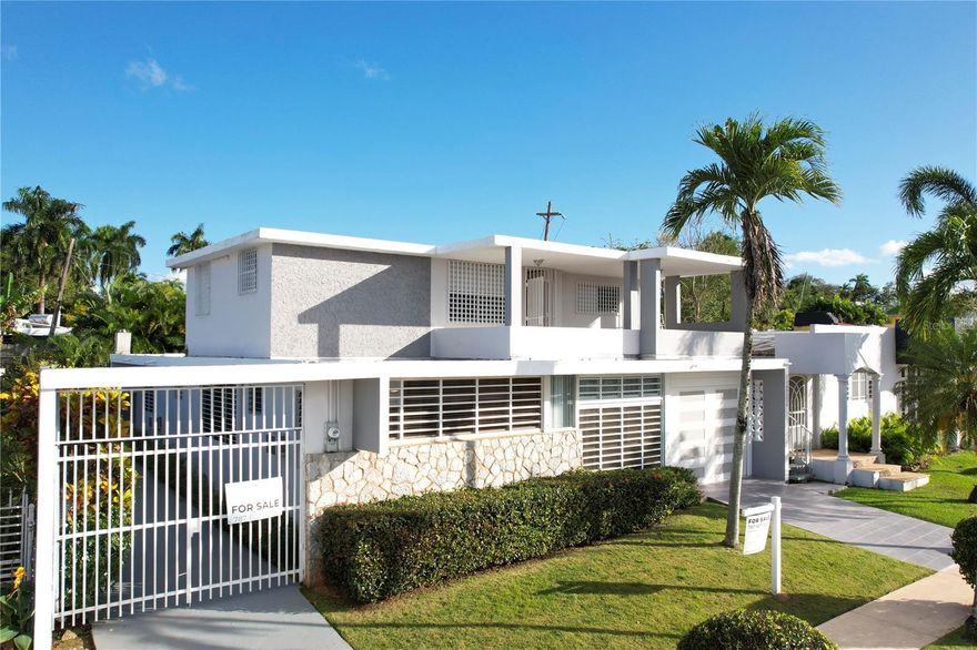 This gorgeous and well-maintained property is located the well-known gated community Sagrado Corazon, centrally located in Cupey, San Juan. The unit consists of 3 bedrooms and three full bathrooms on the first floor. The accessory unit on the second floor, which includes an independent entrance, consists of a spacious bedroom, living/dining area, a full bathroom, Kitchen area and an ample terrace with a view. The property offers an open kitchen, spacious family room, laundry area, nice backyard, separate storage room and a power generator. Another wonderful feature about this property is the high ceilings all over and all the natural light that comes in, making it feel very open and breezy. The unit on the second floor could be used as an accessory unit to the main home or could generate passive income if desired.