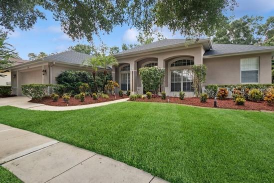 Situated on a Cul de sac, this beautifully maintained 4-bedroom 3-bathroom home plus a dedicated office is located in the 24-hour guard-gated community of Heathrow in Lake Mary FL. Boasting 2,499 sf of thoughtfully designed living space, this home offers the perfect blend of comfort, sophistication and convenience. As you enter the elegant leaded glass front door you are greeted by high ceilings, rich wood flooring and expansive living areas bathed in natural light. The updated kitchen that opens up into the family room is a culinary delight, featuring granite counters, soft close cabinets, a convection oven, ample counter space and stainless-steel appliances--ideal for entertaining or quiet evenings at home. The spacious primary bedroom suite includes a sitting area, walk-in closet and allows access to the lanai. The triple split floor plan offers privacy and flexibility. The roof was replaced in 2018 and the hot water heater in 2023 ensuring peace of mind. The solar heated pool was resurfaced in 2017 and pavers were installed to give the lanai a polished look. The pool has a special feature that drains the pool after a heavy rain fall to avoid overflowing. For convenience, pool functions are controlled by Pentair Easytouch control system. Relax and unwind in the screened pool and spa and entertain under the 25-foot covered patio. Residents have access to soccer and baseball fields, basketball courts, picnic areas, a fishing dock on Lake Sawyer and a clubhouse that is available for rental, all a short distance from this property. Heathrow is 45 minutes from the Orlando International Airport, Disney World, Universal, Dr. Phillips Performing Art Center, New Smyrna Beach and many golf courses. Heathrow is home to Heathrow Golf Club and members also can play at Legacy Golf Club, just across the street. Shopping and many restaurants are minutes away. This property may be under visual/audio surveillance.