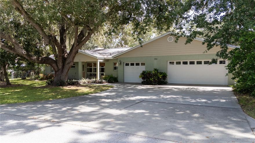 Just five minutes from downtown Sarasota, this unique 1.5-acre property offers space, versatility, and opportunity. The main residence features three bedrooms, three bathrooms, and a two-and-a-half car garage, while the detached one-bedroom, one-bath cottage with full kitchen is perfect for guests, extended family, or flexible use as a game room, home office, or creative retreat.

Inside the main home, the chef’s dream kitchen includes three ovens, two sinks, and plenty of counter space for prep and serving. A beautiful, inviting front porch with floor-to-ceiling windows fills the home with natural light. The living room boasts a warm brick fireplace with built-in shelving, while a separate TV room with French doors opens to the oversized screened lanai. From the lanai, you’ll enjoy serene garden views that make the outdoor space a true extension of the home.

With two separate entrances, the property is ideal for a family compound, a business owner needing space for equipment, or potential future development. The home is located in a non-flood zone, has a durable metal roof, and includes two air conditioning units, one of which is brand new. Centrally located near Benderson Park and I-75, and just 21 minutes to the beautiful Gulf Coast beaches, this is a one-of-a-kind Sarasota estate with endless possibilities.

The adjacent 1-acre parcel is also available for purchase and may be combined with this property for an expanded homesite or added privacy.
