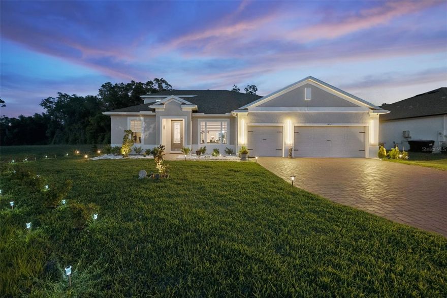 Located on a PREMIUM CORNER LOT, this 2025-built luxury home with a screened-in heated saltwater pool delivers the perfect blend of modern design, privacy, and high-end upgrades. With NO REAR OR LEFT SIDE NEIGHBORS and backing to a wooded conservation area, this property offers rare seclusion in a highly desirable setting. This stunning 5-bedroom, 4-bath home with a dedicated office/den and 3-car garage features a bright, open-concept layout with 10' ceilings, 8' doors, tray ceilings, wood-look tile flooring, 5 1/4" baseboards, and designer finishes throughout. Step inside to a formal dining area and a private office with French doors providing both elegance and functionality. The split floor plan enhances privacy, highlighted by a first-floor primary suite with direct access to the pool and patio, creating seamless indoor-outdoor living. The suite features a garden tub, an oversized walk-in shower, dual vanities, and a large custom closet. Upstairs, a private retreat includes a spacious bedroom and full bath, ideal for guests or multigenerational living.The chef's kitchen is built to impress, featuring a massive quartz waterfall island, built-in double ovens, a gas cooktop, premium stainless steel appliances, ceiling-height white cabinetry, and a walk-in pantry, designed for both everyday living and entertaining. A convenient pool bath with double sinks and an upgraded shower door offers direct backyard access. Step outside to your own private resort-style backyard on an oversized .36-acre lot, featuring a new screened-in heated saltwater pool, a sealed paver deck, ambient pool and outdoor lighting, lush landscaping, and recently planted Italian cypress trees that enhance both privacy and luxury appeal. The 3-car garage offers epoxy flooring, built-in storage, and an upgraded LiftMaster garage door, blending style with functionality. Additional upgrades include a water softener system, gutters, custom blinds, upgraded light fixtures, a shed, a pool privacy screen, a pest control system, security system and much more. With a minimal HOA, this home delivers the perfect balance of privacy, luxury, and location! Just 5 miles from Downtown Mount Dora and about 30 minutes to Orlando. A rare offering featuring a premium lot, new construction, a resort-style pool, and luxury upgrades throughout, truly move-in ready. POOL AND PATIO FURNITURE INCLUDED WITH FULL PRICE OFFER.