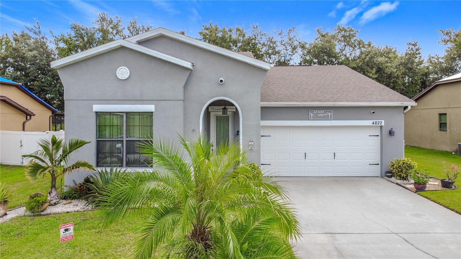 Under contract-accepting backup offers. Stunning 4-bedroom, 2-bathroom home with serene lake views and a wealth of upgrades! The spacious kitchen boasts 42" tall cabinets with crown molding, granite countertops, and a convenient built-in desk, perfect for home organization.The remodeled primary bathroom features a soaking tub, double sinks, a walk-in closet, and a Bluetooth-connected exhaust fan system. The second bathroom also includes a fan with built-in music controlled via Bluetooth. Elegant moldings and blinds throughout the home add a touch of sophistication. The great room impresses with a decorative stone accent wall and an electric fireplace, complemented by a stylish barn door, while the entryway features a beautiful stone feature wall.Outdoor living is a highlight, with a screened lanai, extended paver flooring, and a durable PVC fence, ideal for entertaining and enjoying the lake view. The garage includes epoxy flooring, a built-in closet, attic access via staircase, a smart garage door motor controllable via phone, and an exterior keypad.Additional features include a laundry room with new cabinets, washer, dryer, and a new glass door. The home also offers a modern security system with Ring cameras (one indoor, two outdoor), gutters installed 5 years ago, and exterior paint refreshed 3 years ago. Major systems updates include a new roof (2024), water heater (2025), and A/C (2013).This home perfectly combines comfort, style, and functionality, making it truly move-in ready in a desirable location.