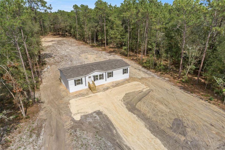 BRAND NEW NEVER LIVED IN BEFORE spacious Double-Wide home located on an Oversized 2.37+/- acres lot in Lake Tropicana Ranchettes with additional field fencing on all four property lines. NEW LIME ROCK DRIVEWAY! Located on a paved road! Beautiful 4 bedrooms, 2 full bathrooms with brand NEW everything inclusive of septic system, well, electric, AC, field fencing with entrance gate! Spacious Master bedroom includes walk-in closet, along with double vanity sink bathroom and shower bathing areas. Three additional large bedrooms each with roomy closets inside. High quality kitchen with brand NEW Stainless Steel appliances included. Features floor to ceiling cabinetry and multi-purpose kitchen island. Perfect for cooking, dining, or working! Just a few steps away is a utility area with space to plug in a washer and dryer and an easy access door to the backyard. Ample room to entertain and relax in the Living and Dining rooms. MOVE-IN READY ! Quiet, calming location. Zoned A-2, Bring your farm animals