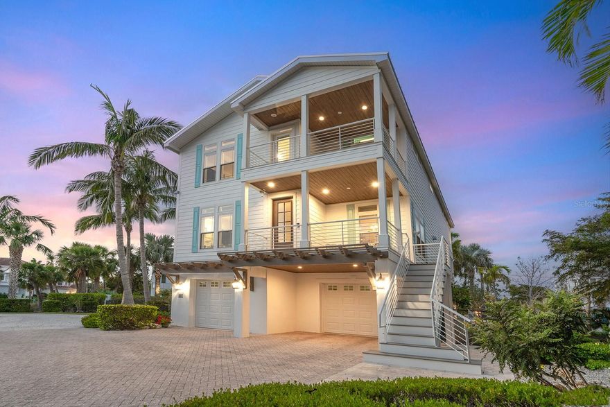 Price improvement! Discover your coastal retreat in the heart of Siesta Key, where lush gardens create a relaxing oasis near the Gulf. This stunning four-bedroom, three-and-a-half-bath coastal contemporary home offers a blend of luxury and convenience, perfect for full-time living or as your ideal vacation residence. Just .2 miles from the pristine, powdery white sands of Siesta Beach and only a half mile from the charming shops and restaurants of Siesta Village, this home offers an unbeatable location. With everything you need nearby, you can park your car and unwind in paradise. The moment you step inside, you are greeted by a color palette inspired by the sea and nature, creating a bright and welcoming atmosphere. The open-concept floor plan features a great room with built-in cabinetry and fireplace, a dining area, and a chef’s kitchen and breakfast bar, which boasts custom cabinetry, quartz countertops and a suite of GE Café appliances, including a smart 5-in-1 oven, wall convection oven and a five-burner range with a pot filler. New pendant lighting and dining chandelier add to the inviting feel. The new, custom-designed bar room is the perfect place to gather and enjoy a cup of coffee in the morning with the new Miele coffee system, as well as watch sporting events with family and friends. Entertaining will be a pleasure with the two Uline wine refrigerators and freezer drawer. A private balcony overlooks the pool, with direct access to the expansive backyard via a curved staircase. A bedroom on the main floor doubles as a second primary suite, offering a luxurious en-suite bath, complete with stone countertops, custom cabinetry, glass subway tiles, and river stone floors—a convenient half bath rounds out the main level. Upstairs, the home offers even more space with a bonus room equipped with a mini kitchen and a west-facing balcony for those unforgettable, mango and fuchsia Siesta Key sunsets. The primary suite includes a private balcony overlooking the pool, while two additional guest bedrooms and a shared bath complete the upper level. Throughout the home, you'll find high-quality touches, including crown molding, transom windows, tray ceilings, and wide-plank wood and bamboo flooring. Go outside and discover the gem of this home, the professionally landscaped gardens. Tropical and lush, the private oasis offers ample space to sunbathe, swim in the large freeform saltwater pool, or relax under covered areas designed for entertaining, dining, and lounging. After a day at the beach, the outdoor shower will quickly become a favorite. In the evenings, gather around the fire pit to stargaze or unwind with family and friends. This home also boasts numerous upgraded amenities, including a new three-floor elevator from the garage, metal roof (2023), Lennox five-ton HVAC (2024), fresh exterior paint, wood balcony ceilings, garage doors (2022), newly renovated great room and bar room with custom built-ins, a whole-house gas generator, irrigation well and eco-friendly faux turf. With Hardie board siding, a paver driveway, and extensive landscape lighting, this home is both functional and beautiful. Ideally located on Siesta Key, close to Out-of-Door Academy and only 15 minutes from downtown Sarasota’s vibrant shopping, dining, and cultural attractions, this home is move-in ready. Don’t miss out on the opportunity to own a piece of paradise; your dream home awaits!