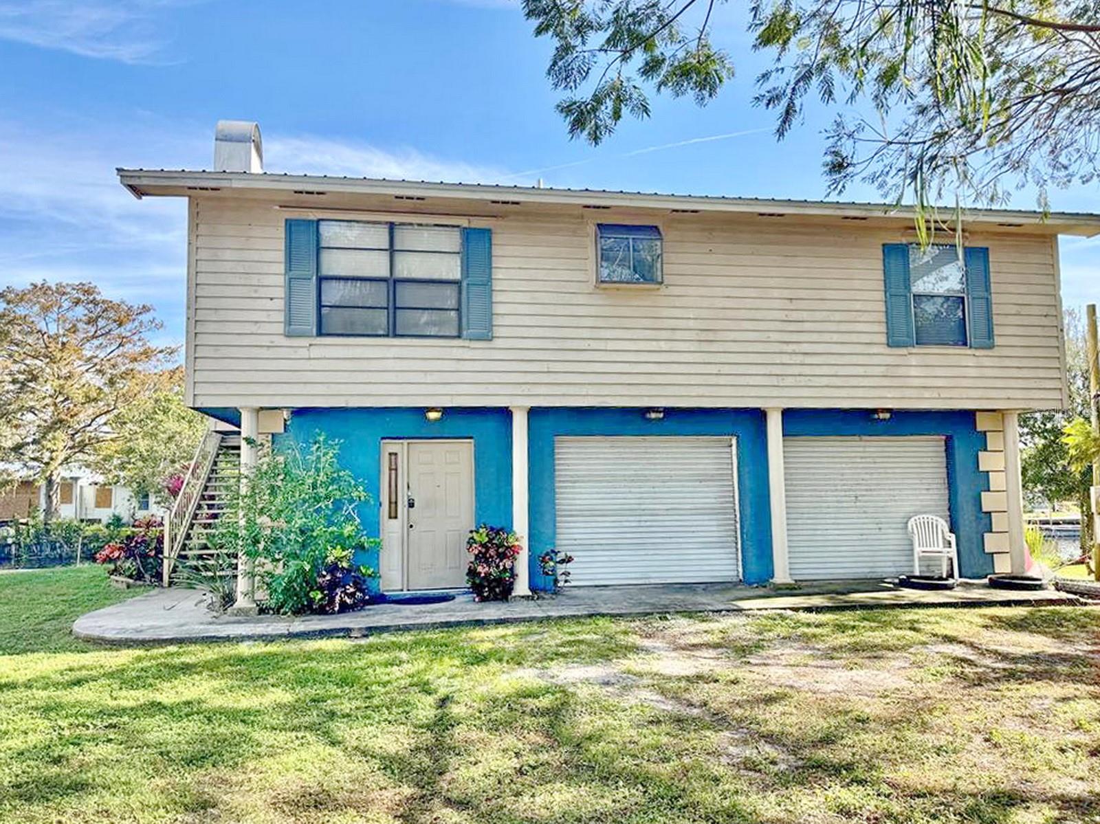 Lake Okeechobee Access - go to both coasts - 2 car garage on bottom with bathroom and laundry room with office. 2/1 updated home, with fireplace, overlooks water with balcony. This is such a nice home.
Please come and take a look.