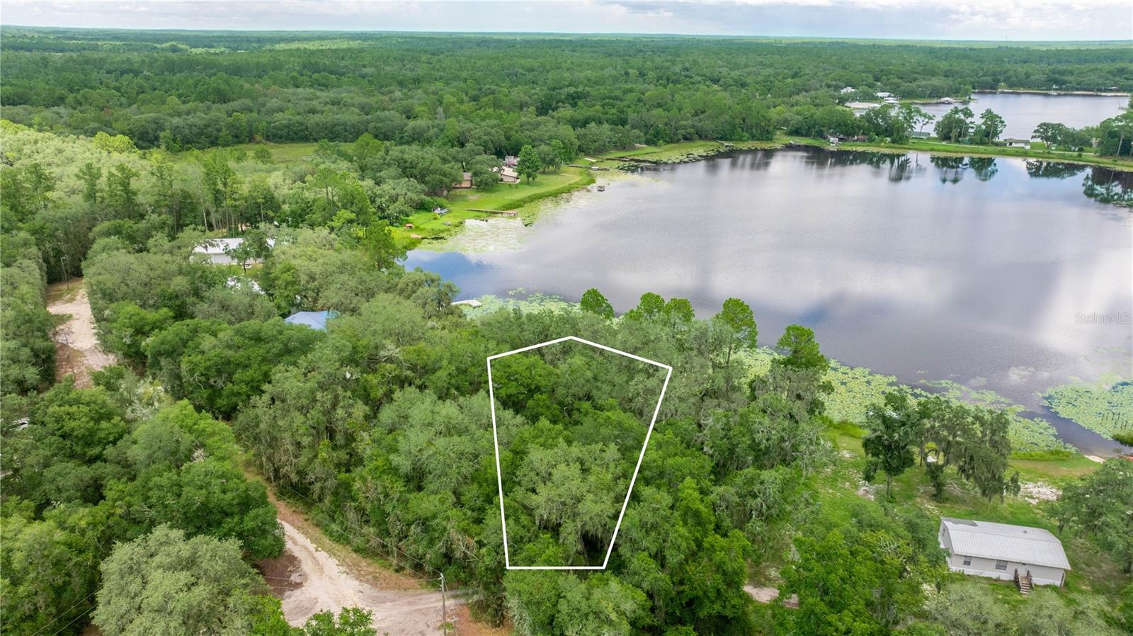 Escape the hustle and bustle and embrace the laid-back lifestyle on this lakefront tract along the serene, private waters of Miles Kale Lake. Surrounded by a collection of other exclusive lakes, this property offers an affordable opportunity to enjoy true waterfront living. The lot boasts mature oaks and lush greenery within a quiet, close-knit community. Outdoor enthusiasts will appreciate the abundance of nearby activities, including water sports, fishing, hiking, and hunting. Local springs, scenic state parks, shopping, and dining are all just a short drive away, making this a perfect balance of tranquility and convenience.