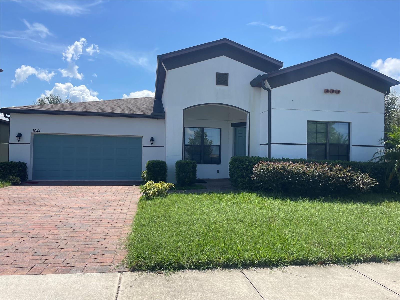 Welcome to this beautifully maintained 4-bedroom, 3-bathroom single-story home located in the sought-after Stonewood Estates community. Nestled just off N Narcoossee Rd, the home offers convenient access to Hwy 192, top-rated schools, shopping, dining, Orlando International Airport, and more. Inside, you’ll find a bright and spacious open floor plan with a combination of tile and carpet flooring, along with a 2-car garage. The kitchen boasts granite countertops, ample cabinetry, a full suite of stainless steel appliances, and a center island—perfect for casual dining and entertaining. The living room is filled with natural light and the dining area opens to a covered patio through sliding glass doors, creating an ideal space for gatherings or relaxing evenings. The generous primary suite features a walk-in closet and an en-suite bathroom complete with dual vanities, a walk-in shower, and a large soaking tub. Three additional bedrooms offer plenty of space and storage and share a well-appointed full bathroom. Just a short walk away, enjoy the community’s inviting pool—perfect for sunny Florida days. This home is professionally managed and includes Tesla solar panels for energy efficiency. Don’t miss the opportunity to live in this vibrant community and stunning home!