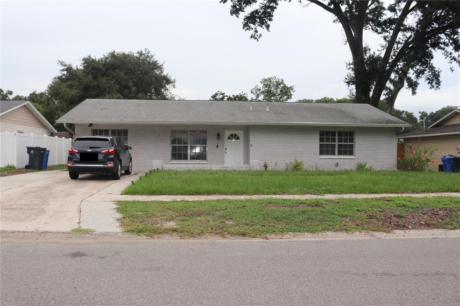 This spacious 4-bedroom, 2-bathroom single-family home offers comfortable living with modern conveniences. The property features durable, solid flooring throughout—no carpet to maintain. The highlight of this home is its expansive backyard, complete with a covered patio area that's ideal for entertaining guests or enjoying family gatherings year-round. Location couldn't be more convenient. You'll find yourself just minutes away from shopping centers, with quick access to I-75 for easy commuting. Whether you're heading to downtown Tampa for work or catching a flight at Tampa International Airport, this home puts you in the perfect position for both convenience and comfort.