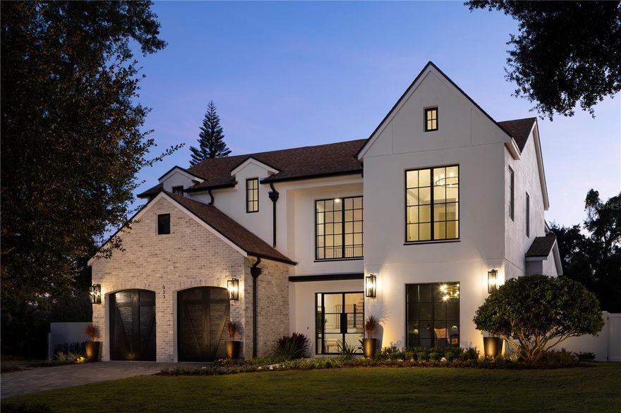 Stunning modern residence boasting almost 5,000 square feet, located in the heart of Winter Park. As you step through the glass front doors, you’re immediately greeted by the grandeur of the marble entry floors, setting the tone for the exceptional finishes throughout this beautiful home. From the gorgeous wood floors laid in a herring bone pattern, to the custom staircase, designer light fixtures, and beautiful mill work, no expense was spared in the construction of this exquisite residence. This luxurious home features two primary bedroom suites both with large walk-in closets and lavish bathrooms that would rival even the most prominent spas. The chef’s kitchen features exquisite custom cabinetry, porcelain countertops, a walk-in pantry, and top of the line appliances including a ILVE Nostalgie range, and a Dacor wine refrigerator for storing up to 100 bottles of your favorite wine. The bright open floor plan connects the family room, dining area, and outdoor spaces, making it a perfect home for entertaining. On the second floor you will find a total of 4 bedrooms, three bathrooms, a second laundry room, and a secret door that leads to a spiral staircase and a private roof top deck overlooking Lake Berry and views in the distance of downtown Orlando. Situated on a spacious lot, this property features a large, fenced yard with mature landscaping, perfect for outdoor activities and entertaining. The highlight of this home is the inviting pool, providing a refreshing oasis for those hot summer days. Jump on your golf cart and within minutes you’re transported to Park Ave, with its amazing shops, fine dining, and everything else that Winter Park has to offer. Schedule your private showing today and experience the epitome of luxury Winter Park living.