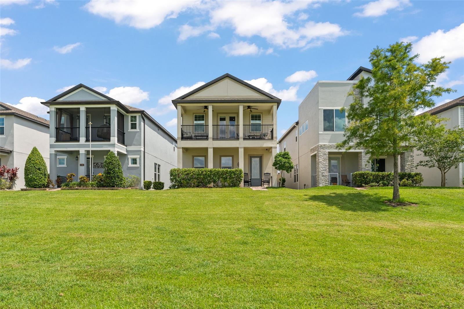 **This property qualifies for a closing cost credit up to $8,400 through the Seller’s preferred lender.** Welcome to a beautifully designed two-story single-family home featuring 3 bedrooms, 2.5 bathrooms, and a detached garage, nestled in a serene and manicured community. As you arrive, you're greeted by a welcoming front porch and an upstairs balcony offering peaceful views of a sleekly trimmed, expansive green space – perfect for morning coffee or evening unwinding. Step inside to discover a light-filled layout where the stairs to the second floor greet you and a cozy living room sits to your left, with windows looking out onto the porch. The open-concept kitchen, dining, and living area creates a comfortable flow for everyday living and entertaining. A convenient half bath is located just off the main space. The kitchen is a modern chef’s delight with dark cabinetry, white quartz countertops, stainless steel appliances, a small island, and breakfast bar seating illuminated by stylish lighting. The adjacent living room features windows facing the covered patio and French doors that lead you outdoors. The dining area offers ample space for a six-seater table and is surrounded by natural light. Upstairs, you’ll find a versatile loft space with French doors that open to the balcony, providing the same calming view as the porch below. The entire second floor is carpeted for comfort. Down the hall are two guest bedrooms with built-in closets and a full bathroom featuring dual sinks, dark cabinetry, and a tub/shower combo. The spacious primary suite is a private retreat, showcasing a tray ceiling, a walk-in closet, and an elegant ensuite bathroom with dual vanities, a glass-enclosed walk-in shower with tile surround, and a rain showerhead. With its thoughtful layout, charming outdoor spaces, and upscale finishes, this home is ready to welcome its next owner. Just 4 houses down from the community pool and also located next to the W Orange bike trail which many use to go to downtown Winter Garden/Plant St, you wont want to miss your chance to experience the blend of comfort and style that 1787 White Feather Loop has to offer!
