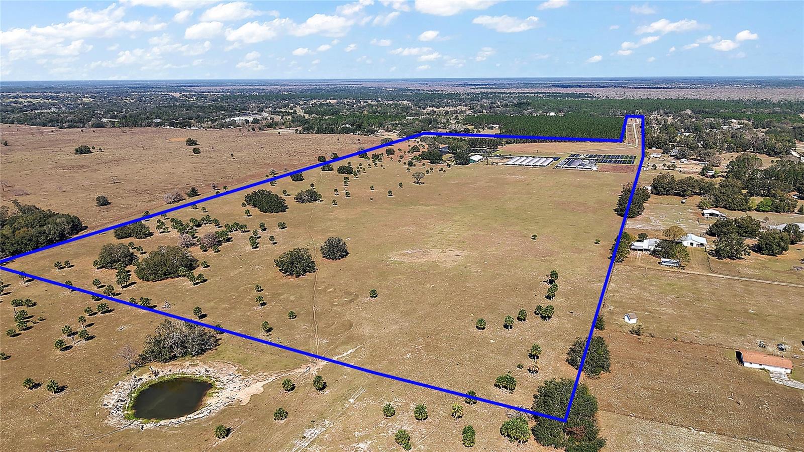 Under contract-accepting backup offers. Vast and open land in Eustis.Gross acreage approximately 68 Acres. The property is located in Lake County’s jurisdiction. Specifically in Northeast Lake County. It consists of three adjoining parcels. Lake County Parcel ID numbers: 04 19 28 0002 000 05600 (Alternate Key 3792273), 04 19 28 0002 000 00400 (Alternate Key 1710961), and 33 18 28 0003 04300. The property is currently zoned Residential; however, the land has agricultural status. Water Source: Five 4” wells on site. 6” mainline irrigation for approximately 8 acres of plant production. There is a Septic Tank for office bathrooms. Buildings: 60’ X 120’ Metal building with reception area, 3 large offices with 1 private bathroom. 2 separate employees’ bathrooms with 3 stalls and 1 shower each. A large break room and exterior stairs leading to storage above office building, 1 Concrete block storage building, 2 framed storage buildings, and under roof parking bays. OTHER STRUCTURES: 180’ X 180’ Deep Shade Greenhouse Structure 2 180” X 100’ Shade Structures. Nursery acreage (10-12 Acres) is fenced, cross fenced gated and front gate entry locks. Cows are grazing on the back parcel.