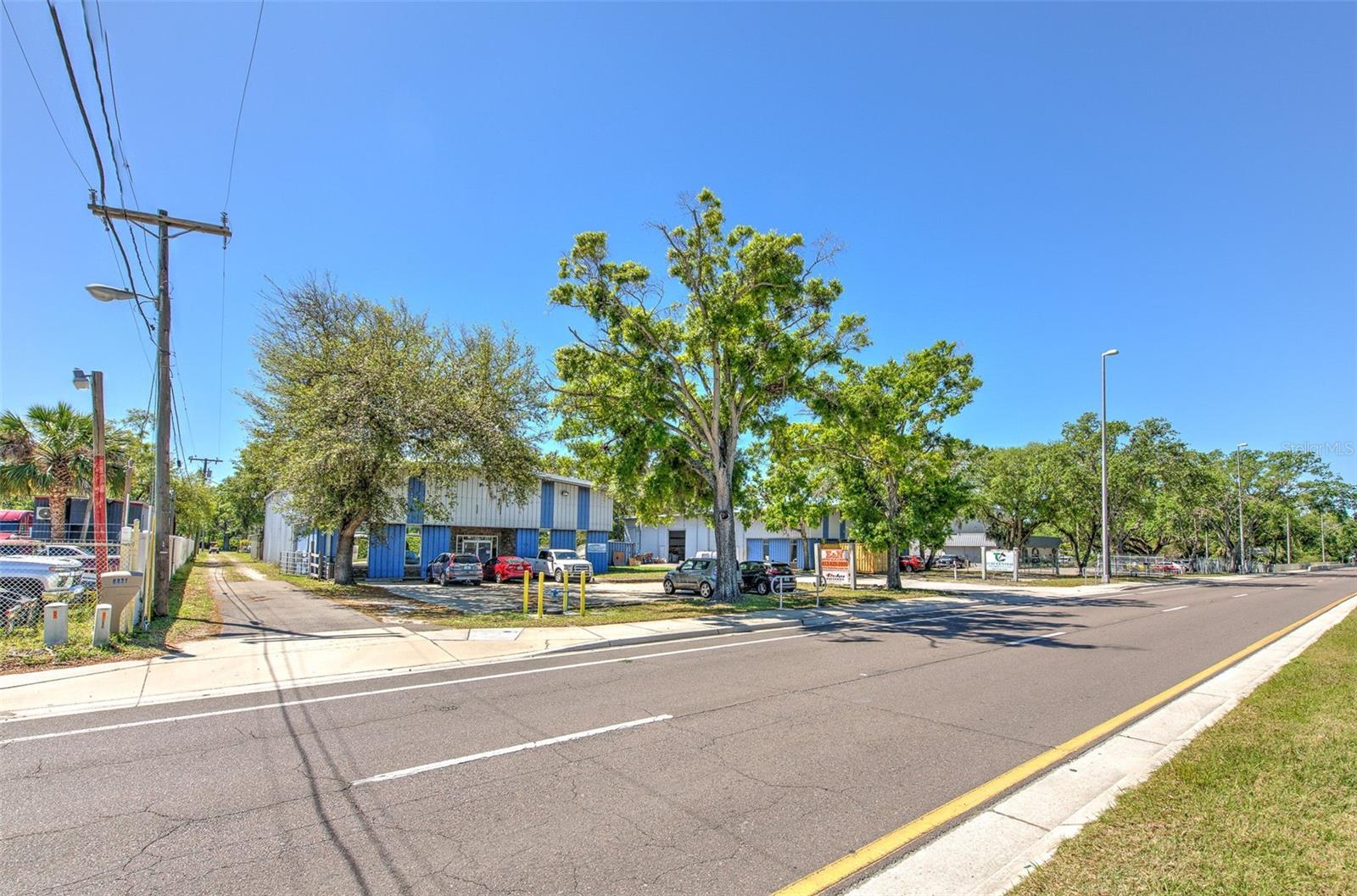 Prime Mixed-Use Potential. A total of 2.082 acres with .61 acres zoned CI — potential to rezone all to CI! Includes house, 3.5-car port with 8,000lb lift & 5 HP compressor, 12’ awning, 750 sq. ft. building with roll-up door, and two storage containers. Convenient access to major highways. Owner financing available at $100k down $6000/month.
