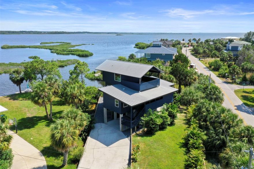 Auction Property. Auction held live on site at the house SAT May 30th at 1pm. List Price is the Opening Bid. Sold free and clear of all liens. Welcome to your dream coastal retreat on Pine Island in Weeki Wachee, where every sunrise and sunset paints the sky in vibrant hues and you have water views from every room! This stunning 3-bedroom, 2-bath home has been transformed into a luxurious haven with top-notch coastal modern finishes that blend elegance and comfort. Imagine driving up to your oasis, parking under your elevated home, and relaxing in a charming seating area with serene water views. Your private paradise features a brand-new sea wall with steps leading to your secluded beach and direct gulf access—perfect for your boat or launching a kayak. The home itself is a masterpiece, with new hardie siding painted in deep blue that complements the shimmering waters. Expansive balconies with new composite decking and sleek cable railings offer perfect vantage points for savoring the breathtaking surroundings. Inside, the open-concept design showcases picture windows and wall-to-wall sliders framing spectacular water views. The kitchen is a chef's delight, with custom cabinetry, exotic level 5 natural stone countertops, a custom designer backsplash, and state-of-the-art GE café series appliances. Every detail, from custom light fixtures to the chic bar area, has been thoughtfully crafted to create a functional and beautiful space. Luxurious LVP flooring flows throughout, while smooth level 5 walls enhance the coastal vibe. The guest bathroom, with custom tilework and designer fixtures, exudes sophistication. Each of the two main-floor bedrooms opens onto private balconies overlooking the water. Ascend to the top floor, where the primary suite awaits—an expansive sanctuary with vaulted ceilings and eastern and western views over the Gulf. New hurricane-impact windows and sliders flood the space with natural light. The master bath is a spa-like retreat with a spacious closet, separate tub and shower, and a private balcony overlooking the water, where you can enjoy your morning coffee or soak in the oversized tub with views of the moonlit sky. This one-of-a-kind property offers more than just a home; it’s a lifestyle. Nestled on Pine Island, you'll be surrounded by nature, with dolphins, manatees, and otters as your neighbors. A boat launch for small to mid-size boats is just steps from your door, and Weeki Wachee River State Park is only 5-10 minutes away. With no rental restrictions, this home also offers incredible potential as a luxury vacation rental. Make it your private getaway or an income-generating paradise. Take a leisurely walk or hop on your golf cart to Alfred McKethan Pine Island Park, a 3-acre Gulf-front oasis with a beach, playground, volleyball courts, and a concession stand. Pine Island is a charming community, 6 blocks long and 2 blocks wide, with only about 40 homes. The optional HOA ($40/year) grants access to a private community dock, boat ramp, and beach. Experience the magic of island living—your ultimate Florida escape awaits. Schedule your showing today and make your island dreams come to life!