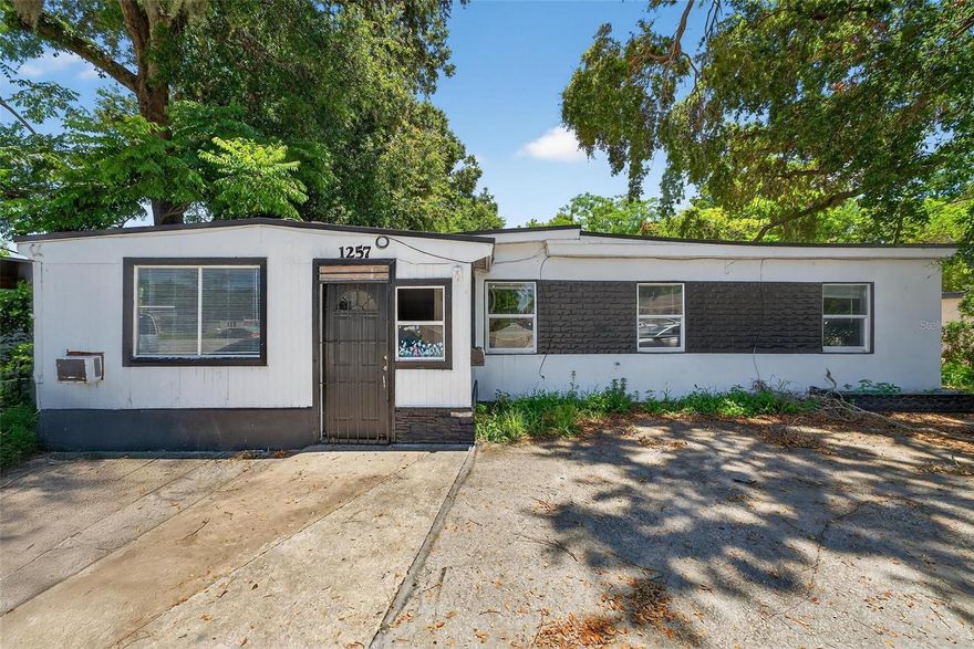 Fantastic opportunity for investor success. This property may be used for professional office space or community residential. As a community residential property, the last tenant was paying $2,800 per month. There are six rooms, plus a general living space, an entry, a kitchen, and a separate self-contained office with a private entrance. Orange County currently has a program in place to connect the property to the public sewer system with no connection fees to the new owner (while the program lasts). Needs only minor cosmetic updates to begin generating income for you. Property sold strictly "as is".