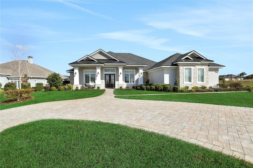 EXQUISITE LAKEFRONT PROPERTY SITUATED IN GATED EMERALD PALMS COMMUNITY, CUSTOM HOME "BUILT BY WATERS" with every award-winning detail, making this exceptional property a true 4bedroom 4bath plus office dream home!!! Thoughtfully designed, this home is perfect for entertaining & enjoying the sunny Florida lifestyle! Custom grand-scale windows allow for glimmering natural light. The Chefs kitchen combines beauty & functionality. Quartz countertops, custom cabinetry and the most incredible 6-burner “Fulgor Milano” gas stove, make this kitchen a cook's paradise! The walk-in “butlers” pantry provides tasteful storage for your kitchen’s smaller appliances. Enjoy the open feel while sitting at the magnificent quartz island and taking in the tranquility of the lake views. Relax on the Travertine lanai with heated salt-water pool & spa, perfect for “al fresco” dining year ‘round! This wonderful, casual space boasts a covered summer kitchen with all of the bells & whistles! Wide-plank neutral tile flooring contributes to the overall casual elegance of this special home as do the tongue & groove patio ceilings. The tranquil setting with no rear neighbors creates quiet spaces for enjoying nature. The triple-split bedroom plan will give your guests & family a private experience. All four bedrooms were designed and sized for comfort, and the primary suite boasts lake and pond views with a truly luxurious & well-appointed bath. The free-standing soaking tub & separate shower provide a soothing retreat. The California closets are extremely functional and allow plenty of room for storage. This like-new gorgeous contemporary home simply has it all!! The home was built in 2020 and is the perfect combination of "LUXURY MEETS CASUAL ELEGANCE"! Extensive crown molding, contemporary lighting, rustic barn doors, separate private office, an amazing laundry room, brick pavers for parking with circular driveway, a 3-car side load garage. The quiet cul-de-sac location overlooks Lake Winterset on the Chain of Lakes & is nestled on a gorgeous street with multi-million-dollar lakefront properties! This immaculate residence even features an incredible herb & vegetable garden for a healthy lifestyle! This truly is "THE PERFECT HOME" - a must see & you can have it all! Located just minutes to Legoland, medical, shopping & close to the I-4 corridor, centrally located between Tampa & Orlando. Call today for a private showing.