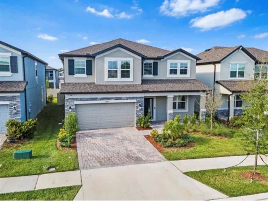 Short Sale. *SHORT SALE*...Discover modern living in this exquisite 5-bedroom, 3-bathroom home in the prestigious Whispering Oaks Preserve, Wesley Chapel. Designed with elegance and comfort in mind, this stunning residence offers an array of high-end features and upgrades, perfect for families seeking a luxurious lifestyle. Some prominent features include an upgraded gourmet kitchen with sleek granite countertops, stylish pendant lights, and stainless steel appliances for all your culinary adventures. Butler's space with a see-through closet pantry enhances functionality and sophistication. With 5 bedrooms and 3 bathrooms, we highlight the Grand owner’s suite on the second floor, featuring sophisticated trey ceilings and a spacious layout. The luxurious owner’s bathroom has a framed shower enclosure, an upgraded dark matter showerhead, a soaking tub, and a double vanity sink. One Bedroom AND full bathroom downstairs, strategically located near one of the five bedrooms, perfect for guests or multi-generational living. The living areas include an Expansive open floor plan with a spacious living room, ideal for entertaining and family gatherings. Versatile flex room with upgraded French glass doors, perfect for a home office, library, or playroom.An Impressive second-floor loft, drenched in natural light, offering endless possibilities for use. Some Outdoor & Additional Features include a Stunning 26x8 screened-in trussed lanai, perfect for outdoor dining and relaxation. A Fenced-in backyard provides privacy and a haven for everyone, including the pets—a 3-car garage for extra space/storage, plus an epoxy-painted floor for a polished finish. Brick-paved driveway enhancing the home's curb appeal. Insulated interior walls and a 6x8 entry door for improved comfort and efficiency. A Charming front porch for welcoming guests and enjoying serene evenings. Equipped with a SMART HOME thermostat and a comprehensive HOME SECURITY feature for ultimate peace of mind. Embrace a lifestyle of luxury and convenience in this remarkable Whispering Oaks Preserve home. Schedule your private tour today and experience this property's unparalleled elegance and comfort. Don’t miss the chance to make this dream home your reality! Floorplan images have been included for your reference. The seller will assist with closing costs upon receipt of a full-price offer.