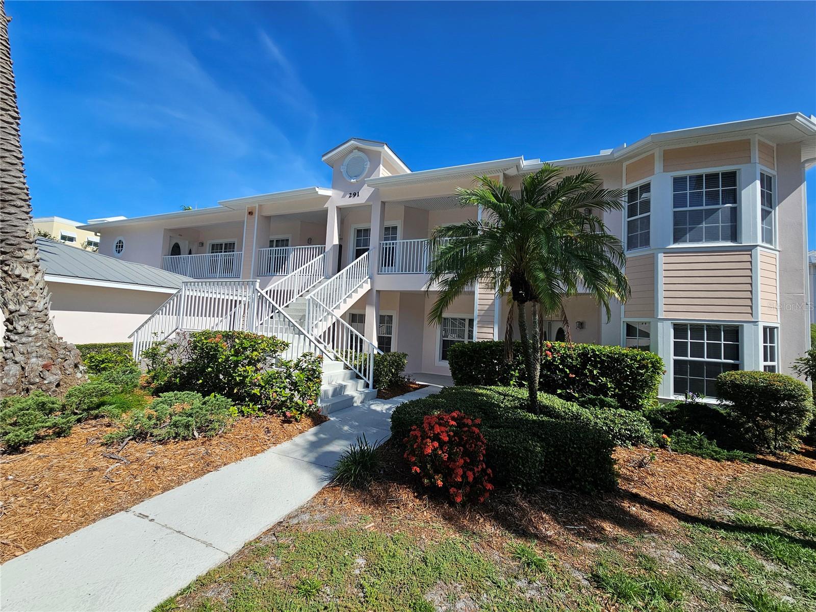 Spacious 2nd-floor end-unit with one car garage (22x11) provides nearly 1,600 sq. ft. and stunning lake and courtyard views. This updated 2BR + den/office (can be 3rd BR) features the largest floor plan in the building, no carpet (tile & laminate throughout), an open-concept layout, and tons of natural light. Kitchen has granite counters, stainless appliances, and upgraded cabinets. Master suite includes two walk-in closets, lanai access, and a spa-like bath with split vanities and garden tub. Second en-suite bedroom has a large closet and private bath access. One-car garage included with open parking or 2nd vehicle.
Lake Vista is a gated, resort-style community located directly on Sarasota Bay with a scenic boardwalk and trail access to the water. Amenities include a heated pool/spa, fitness room, clubhouse, tennis/pickleball, kayak launch, fishing pier & more. Minutes from Siesta Key, shopping, dining, golf, and more.