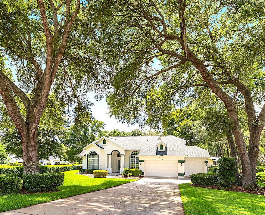 Some places don't just welcome you — they claim you. Nestled within Rainbow Springs Country Club Estates, along a quiet cul-de-sac and a driveway canopied by beautiful oak trees, this home has a way of making the rest of the world fade quietly into the background. Tucked away on a generous .44-acre parcel, this 3/2/3 home offers 1,970 square feet designed for whatever the day calls for — lazy mornings that stretch into afternoon, quiet time to yourself, or a houseful of family and friends who never quite want to leave. The moment you cross the threshold, something shifts. Keys hit the counter, shoulders drop, and your eyes are drawn straight through to the lanai — pulling you forward, wrapping you in warmth, reminding you what home is supposed to feel like. Ceilings climb toward a wash of natural light pouring in through gorgeous windows placed with quiet intention, while living and dining spaces unfold in easy conversation with one another — generous enough for a crowd, warm enough for a still evening alone. The primary suite is a room that earns its name. Sun-drenched and unhurried, it offers the kind of space where mornings arrive slowly and evenings wind down without rush. The ensuite bathroom is its own quiet indulgence — dual vanities, a large walk-in shower, and a soaking tub that asks nothing of you except that you take your time. A generous walk-in closet keeps everything beautifully in its place, and a private door opens directly onto the lanai — so on the mornings you can't quite decide between coffee outside and a long soak, you don't have to choose. The kitchen rises to every occasion. Designed for the one who loves to cook — and for the friends and loved ones who inevitably find their way nearby — it balances beauty and function with effortless grace. Vaulted ceilings lift the space upward, luxury cabinetry with glass-front windows lends quiet elegance, and granite countertops stretch generously throughout.  The spacious island offers extra room to prep, to pour, and to linger, and the built-in stovetop, double ovens, and the deep sink anchor the room with capable charm, while the view spills over the family room and out toward the lush backyard continually reminding you, even mid-recipe, exactly where you are.  But the true heart of this home waits just beyond the back sliding glass doors - a magnificent 26x17 lanai that opens onto a backyard that stops you mid-step - lush, deeply green, and utterly unhurried, unfolding like a private park. Mature oaks frame the edges, birdsong fills the air, and the world beyond feels very far away indeed. And then there is the Rainbow River!  As a resident of Rainbow Springs Country Club Estates, access to one of Florida's most breathtaking natural treasures comes with the privilege of calling this community home. The Rainbow River runs crystal clear at a steady 72° year-round — a spring-fed gem perfect for tubing, kayaking, paddle boarding, and some of the finest snorkeling in the state. For those who prefer land, the Blue Run Trail connects to the Withlacoochee Forest Trail, offering over 48 miles of riding and wandering through some of the most magnificent scenery in North Central Florida.  Shopping, dining, and everyday conveniences are just minutes away, and Ocala — with its world-class equestrian scene, vibrant restaurants, and abundant retail — is a short, easy drive into town. Some places make you want to visit. This one makes you want to stay.