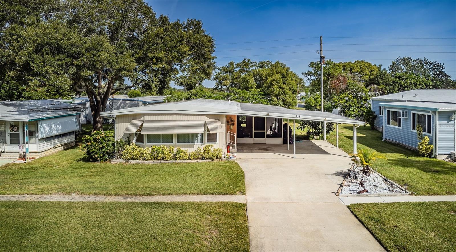 Your Florida dream home awaits in this 55+ community, where you own the land and this fully updated manufactured home is truly move-in ready. As you step inside, the freshly painted interior and recessed lighting throughout create a welcoming ambiance that's sure to brighten your days. Luxury vinyl plank floors throughout exude modern charm. The interior doors and hardware have been updated to enhance functionality and style. Your kitchen is a culinary paradise, boasting exotic granite countertops, freshly painted cabinets with slow-close and pull-outs. Other features include newer windows that tilt in for easy cleaning, updated baths, a new electric panel, tankless water heater and all new ductwork. Pamper yourself in the master bathroom that has been lavishly transformed with a new shower, tile floor, updated plumbing and fixtures. Additionally, the 2 car carport provides shelter for your vehicles. Brand new Leaf Filter gutter guards make exterior maintenance a breeze and the Rainbird sprinkler system is sourced from a well, saving you time and money on lawn maintenance. The Village of Lake Tarpon community offers a resort style pool, shuffleboard, bocce ball, pickleball and a clubhouse along with a community boat ramp for cruising on Lake Tarpon. Boat slips are for rent as they come available. Don't miss this opportunity to embrace Palm Harbor living in style!