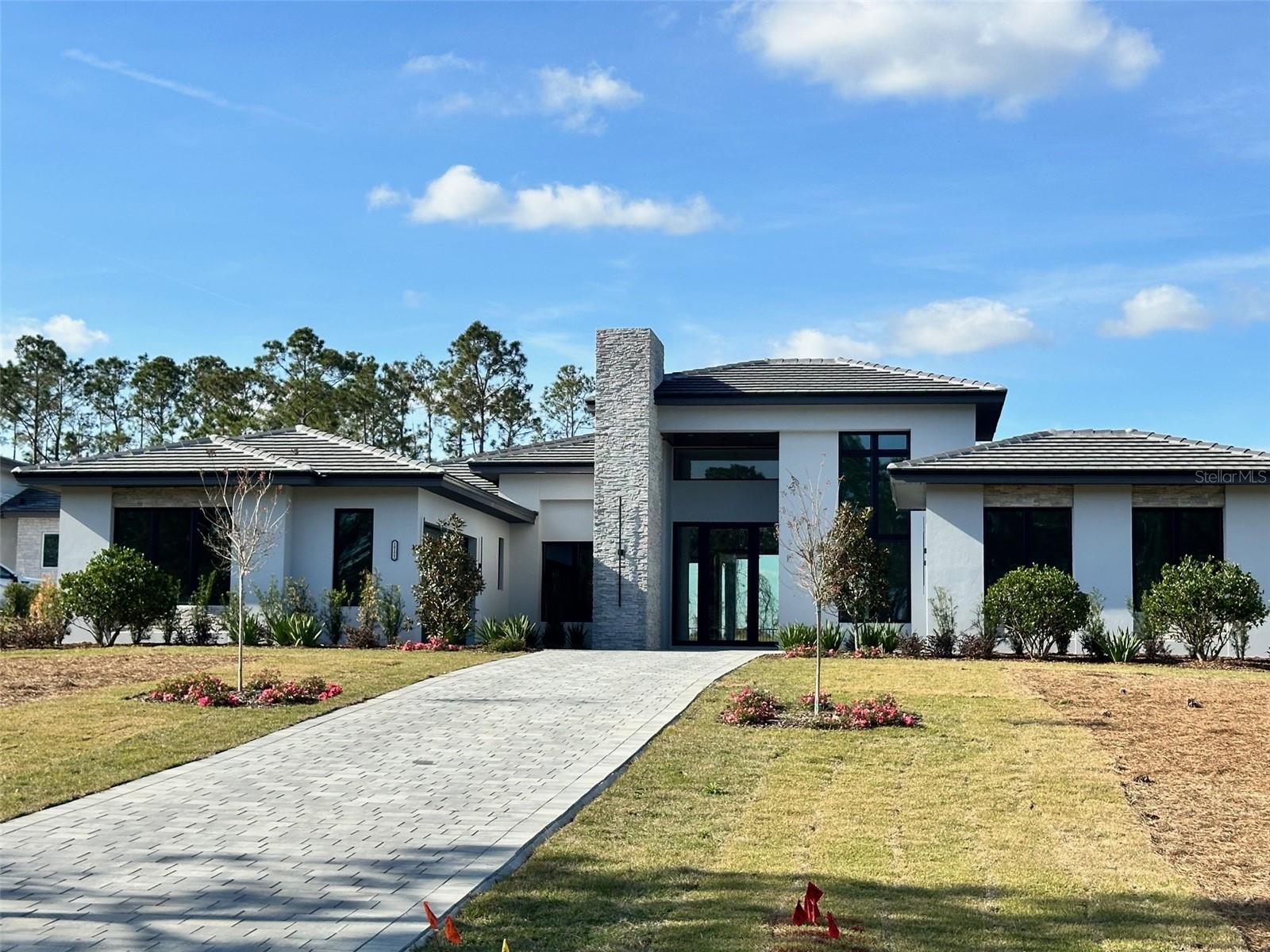 This thoughtfully designed single-story residence combines relaxed comfort with elegant flair, showcasing an open floorplan that flows effortlessly from the soaring-ceiling foyer to the expansive outdoor living area. Architectural ceiling details and statement lighting enhance the home’s elegant design, while the private office also features soaring ceilings, creating an inspiring space for work or study.
At the heart of the home, the gourmet kitchen seamlessly connects to the dining and great room, all overlooking the custom outdoor retreat. Step outside to your private backyard oasis, where a sparkling pool with spa, a fully-equipped summer kitchen, and a putting green provide the ultimate setting for entertainment and recreation.
The owner’s suite offers a peaceful escape with his-and-her walk-in closets and a spa-style bath featuring double vanities, an oversized walk-in shower, and a freestanding soaking tub.
Residents of Bella Collina enjoy a wealth of world-class amenities, including a Nick Faldo-designed championship golf course, resort-style pool, full-service spa, fitness center with complimentary classes, Har-Tru tennis courts, pickleball, lakefront access, and a vibrant calendar of year-round social and culinary events.
Schedule your private tour today and discover the lifestyle that awaits in Bella Collina.