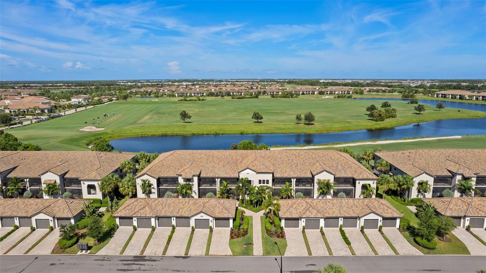 Welcome to the gorgeous golf community at Lakewood National Golf Club. This gated community features 36 holes of the Arnold Palmer designed Golf Course, and the Condo is perfectly situated over-looking the 1st tee box. This End Unit has the unique Arabella floor plan in the veranda style condominium, which is the largest floor plan available and comes equipped with a one car garage. Enjoy the modern finishes & high end appliances. Retreat to the primary bedroom with a large walk-in closet & en suite bathroom. Enjoy the privacy of a den in the middle of the floor plan, perfect for a lifestyle that revolves around family living and housing guests/extended family. Time spent on the lanais, both of which are screened, will be a break only from the ultimate golfing lifestyle, with the chip and putt very close by. A separate resort style pool is right across the street as well. Lakewood National provides a number of amenities besides golf, including Tennis, Pickleball, Community Pools, Tiki Bar, Bocce Ball, & Clubhouse as well as a 24 hour Fitness Center and full service spa are around the corner.