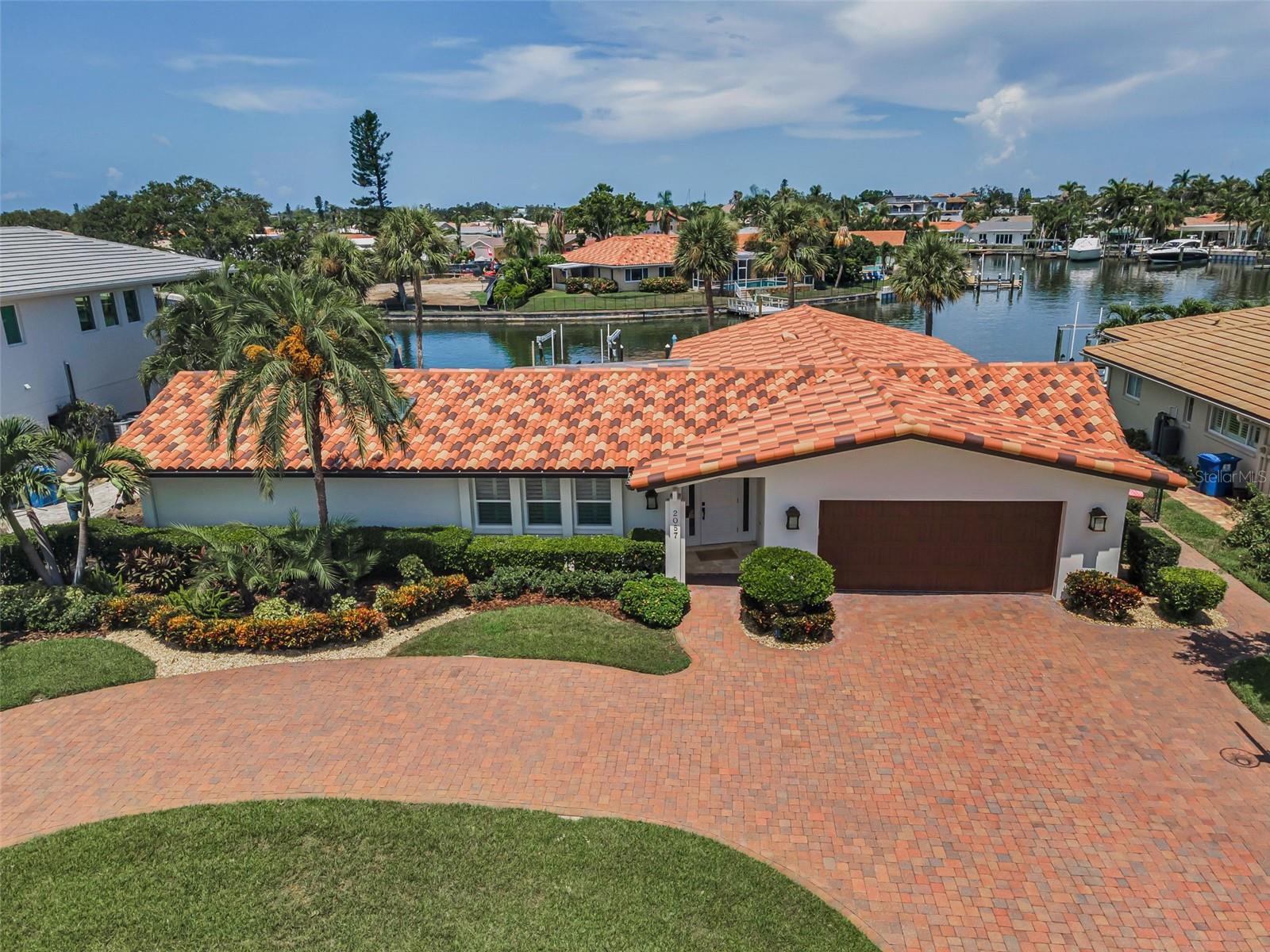 : LOCATED IN ONE OF TAMPA BAY’S PREMIER BOATING COMMUNITIES, THIS LUXURIOUS 4 BEDROOM, 3 BATH WATERFRONT RESIDENCE IS BEAUTIFULLY FINISHED THROUGHOUT; AND WITH NO BRIDGES TO WORRY ABOUT, YOUR BOAT WILL BE OUT IN OPEN WATERS OF TAMPA BAY IN A MATTER OF SECONDS! Lushly landscaped with an exceptional brick paver circular driveway and a fine covered entry, discover a magnificently-updated home with elegant crema mar fil marble flooring complemented by driftwood-style porcelain floors in the bedrooms. The generous great room plan with living and dining areas transitions to a wonderful open concept kitchen with sumptuous custom cabinetry, inviting granite surfaces, Viking stainless steel appliances, a lovely multi-level island bar that overlooks the waterfront, and a kitchen passthrough to the covered outdoor bar area. You’ll love the private owner’s suite with its views of the waterfront, dedicated access to the pool deck and spacious custom walk-in closet system. The dazzling owner’s bath boasts beautiful coastal-white cabinetry, superb granite surfaces, dual vanities, high-end fixtures, skylight, exquisite tilework, and a gorgeous glass rain-shower enclosure. Opening to the pool deck, the generous family room connects three splendidly-appointed bedrooms; two bedrooms are joined by a lavish Jack and Jill bath with impressive tilework, shiplap and quartz finishes. The 4th bedroom opens to the pool deck and is supported by a posh full guest bath that likewise opens to the pool deck (pool bath). You will appreciate the large indoor laundry facility with its dedicated office/work space and terrific built-in storage! Step out to the 330 sqft covered dining and lounging deck overlooking the pool and waterfront. Rich travertine pavers gracefully encase the swimming pool and provide ample space for lounging and sun bathing. Beyond the pool deck rests the composite boat dock with its new 10,000 lb boat lift and step-down area that is ideal for launching kayaks and paddleboards. This remarkable residence enjoys a long list of superior updates and upgrades. From its interior finishes to its impeccable landscaping, the meticulous attention to detail will leave you impressed. Come see why the sellers have called this their “happy place” from the very day they moved in. Dimensions/measurements are estimates, buyer to verify. An outstanding value in a great location near fine shopping, dining and excellent K-12 schools.