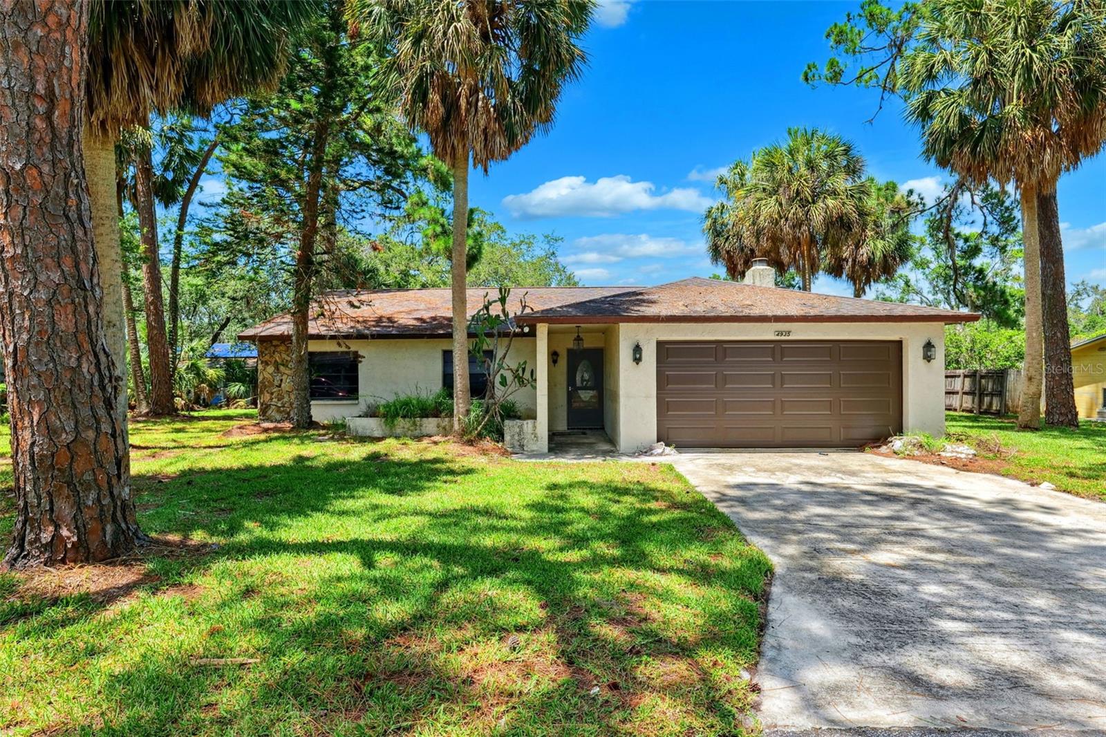 Investor Special – Full Remodel Opportunity! Welcome to 4935 Petunia Court in New Port Richey, a 3-bedroom, 2-bath home with endless potential for the savvy investor or experienced renovator. This property sustained flood damage, and all interior walls have been removed—creating a clean slate for your vision. Nothing inside has been preserved, making this house a true full-gut renovation project. The home features a 2-car garage, a fireplace as a focal point for future living space, and a generously sized yard offering room to reimagine your outdoor oasis. With solid bones and great curb potential, this property is ready to be transformed from the ground up. Whether you're looking to flip, rent, or customize for resale, this is a rare chance to create something special in a well-established neighborhood. Cash or rehab loan only. Sold AS-IS. Bring your contractor and imagination—opportunities like this don’t last long!