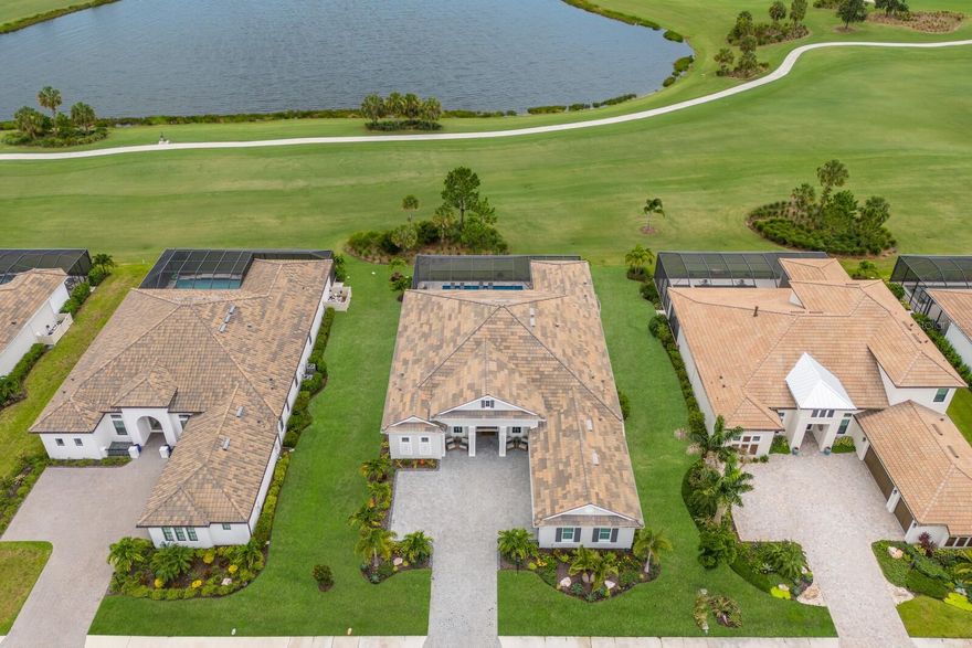 This is your chance to own a rare 90-foot GOLF DEEDED home on the Azario golf course! The builder does not build on 90-foot lots anymore, this is an unbelievable find! This Beacon floorplan is elegantly positioned on the 13th fairway of the highly-rated Esplanade at Azario Lakewood Ranch Golf Course. Offered FURNISHED, this 2022-built home has all of the modern touches in a relaxing setting. Enjoy gorgeous sunsets from your oversized lanai featuring travertine pavers, a spill-over-spa, sunshelf, clear-view pool enclosure, and an amazing outdoor kitchen ready for you to entertain your guests in the Florida sunshine. IMPACT WINDOWS & DOORS adorn the home letting in light from all angles. Inside you will find a chef’s kitchen in the heart of the home featuring all of the latest kitchen design items such as quartz counters, double-stacked cabinets, large natural gas cooktop, upgraded appliances, apron sink, and an oversized island – all overlooking the expansive great room, complete with a fireplace feature wall and 12-foot ceilings. The spacious Den can be used as an office, exercise room, or another room for guests to name a few uses. Located in the sought-after Esplanade at Azario community, this home offers a golf membership, a lifestyle director with daily activities, resort-style amenities, culinary center, fitness center, full-service spa, multiple tennis and pickleball courts, coffee shop, resort pool, and a Bahama-bar & restaurant. This is like living on vacation everyday! Lakewood Ranch is centrally located to fabulous dining, shopping, world class gulf coast beaches and 3 major airports.