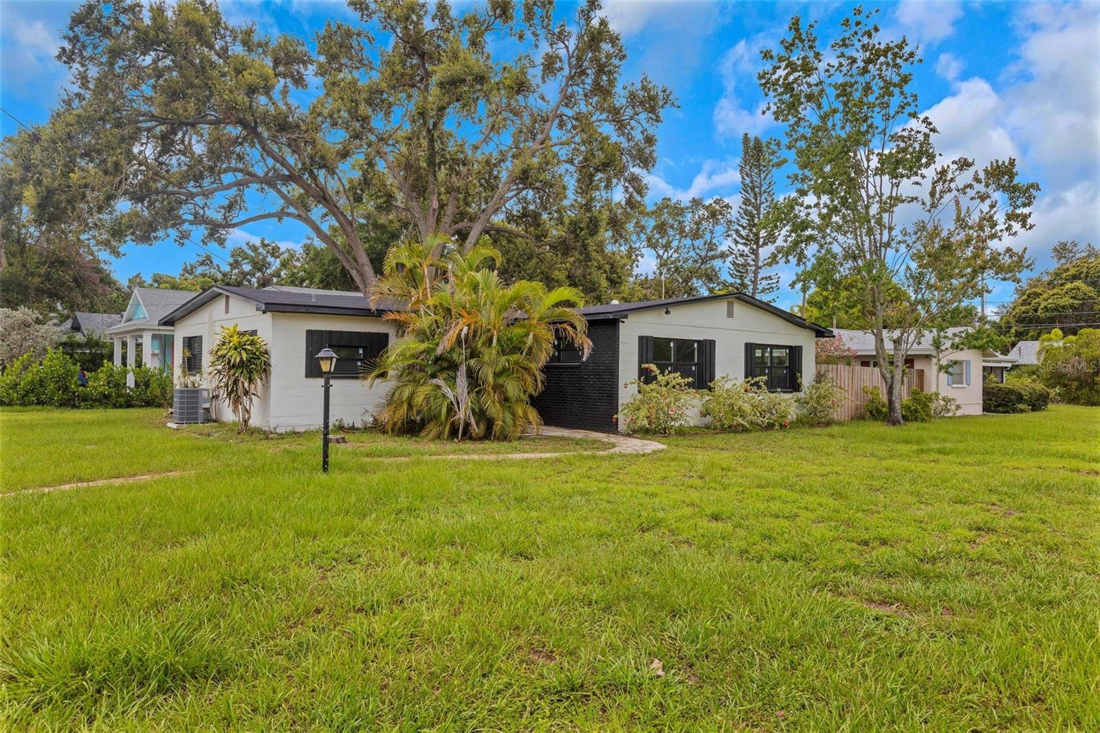 Welcome to your beautifully reimagined home in the heart of Gulfport, FL! Nestled on a spacious corner lot just minutes from lively Downtown Gulfport, the marina, and waterfront dining, this move-in-ready gem blends modern updates with unbeatable location—and it’s not in a flood zone! Step inside to an airy, refreshed interior where everything has been thoughtfully upgraded. The brand-new kitchen shines with sleek appliances and stylish finishes, while both bathrooms have been completely renovated for a clean, contemporary feel. New flooring flows throughout, complemented by fresh interior and exterior paint, updated baseboards, trim, and doors—creating a polished, inviting atmosphere from the moment you walk in. Major systems have been taken care of, too: enjoy peace of mind with a new roof, new windows, and a new A/C system for year-round comfort. The private, fenced-in yard is perfect for relaxing, entertaining, or even adding your own garden or outdoor space. Paid-off solar panels (only four years old) were removed for the roof install and are stored in the garage—Seller is will reinstall solar panels prior to closing with a full price offer or buyer can choose to reinstall them or have them removed post closing. This is your chance to own a thoughtfully updated home in one of Gulfport’s most desirable areas. Whether you're looking for a primary residence or a stylish coastal getaway, this property checks all the boxes. Schedule your private showing today!