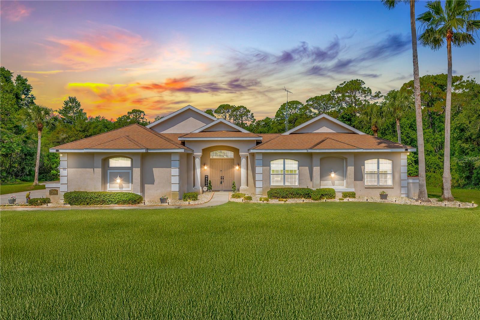 Discover your dream home in the sought-after River Country Estates of Weeki Wachee. This exceptional 5-bedroom, 4-bathroom courtyard pool home offers a unique U-shaped design, ensuring nearly every room has direct access to the expansive 1,400 sq ft screened pool courtyard—perfect for seamless indoor-outdoor living and entertaining. The main residence features 3 spacious bedrooms and 3 full bathrooms, complemented by soaring 10-foot ceilings and abundant natural light. The gourmet kitchen boasts updated stainless steel appliances and ample counter space, making it a chef's dream. The large great room provides direct access to both the back patio and the pool courtyard, offering versatile spaces for relaxation and gatherings. The luxurious primary suite is a true retreat, featuring direct access to both the pool and back patio, dual vanities, a soaking tub, a separate standing shower, and a spacious walk-in closet. A standout feature is the separate 2-bedroom, 1-bathroom guest suite with its own private entrance. Connected to the pool courtyard, this space is ideal for multigenerational living or as a potential income-producing Airbnb. Additional highlights include a spacious 3-car garage, fully paid-off solar panels enhancing energy efficiency, and a backyard that backs to serene green space, providing privacy and a connection to nature. Situated on over an acre of beautifully landscaped grounds, this home offers tranquility while being just minutes from the crystal-clear waters of Weeki Wachee Springs, local parks, and shopping centers. Don't miss the opportunity to own this versatile and stunning property that perfectly blends luxury, functionality, and sustainability.