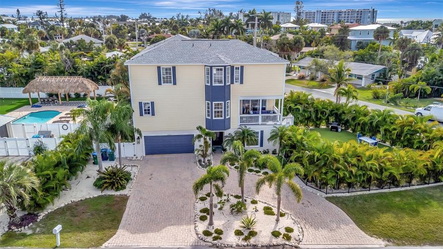 AMAZING LOCATION • COMPLETELY UPDATED • BRAND NEW POOL • BRAND NEW ROOF • TURN-KEY FURNISHED Casa Bella is a spacious and beautifully updated 4-bedroom, 3-bath home offering more than 2,500 sq ft in the heart of Holmes Beach. Located just steps from shopping and dining and only a 5-MINUTE WALK TO BEACH, this property is situated in one of Anna Maria Island’s most desirable WEEKLY RENTAL ZONES, making it an excellent investment opportunity or a ready-to-enjoy personal beach retreat. This home has undergone extensive recent updates, including new wood flooring throughout, a brand-new spool (pool with spa jets), and a brand-new roof. Casa Bella is offered turn-key furnished, featuring a thoughtfully curated collection of artwork and unique furnishings. The coastal-style interior includes a large great room, fully stocked updated kitchen with custom cabinetry, stainless steel appliances, stone countertops, and a spacious dining area. The home comfortably accommodates up to 10 guests, with three bedrooms featuring king beds and a fourth bedroom designed with two twin-over-twin bunk sets—ideal for families or renters. Additional features include A LOWER LEVEL RECREATION ROOM with a ping-pong table, three updated bathrooms with spa-style finishes, 2 owner closets and three screened porch areas, perfect for enjoying morning coffee or evening breezes. Situated on a LARGE CORNER LOT with lush tropical landscaping, the outdoor area offers a private FENCED backyard oasis with ample space for dining, entertaining, and relaxing by the pool. Turn the key and start enjoying the ideal Holmes Beach lifestyle—whether as a personal coastal retreat or a strong VACATION RENTAL PERFORMER, Casa Bella offers flexibility, comfort, and an exceptional location.