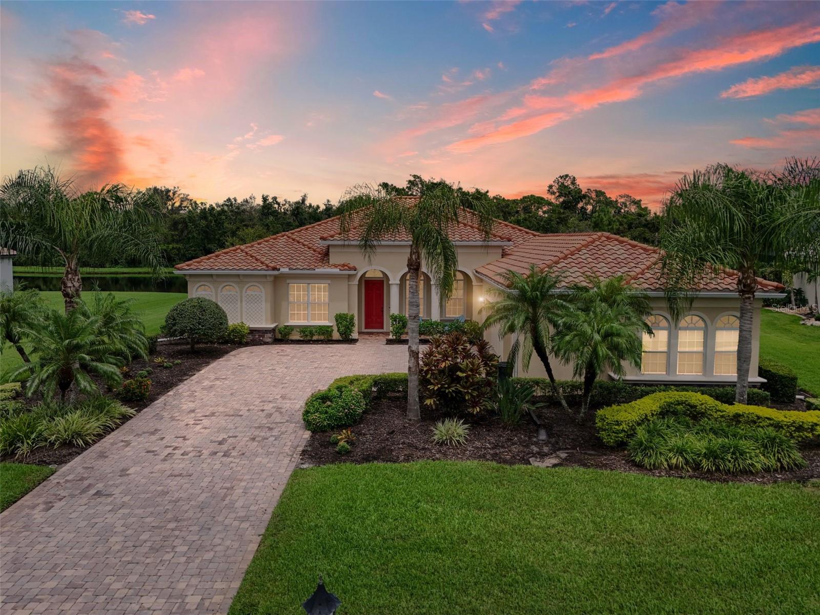 Welcome to this exceptional estate home in the highly sought-after community of Rye Wilderness, where luxury living meets the tranquility of nature. Perfectly situated on a private half-acre homesite with serene pond and preserve views, this 4-bedroom plus den, 3-bath residence spans over 3,120 sq. ft. and combines thoughtful design, modern comfort, and inviting spaces both indoors and out.
From the moment you arrive, the home makes a statement with its stately presence, extended driveway, and 3-car garage—providing ample room for parking and storage. Inside, you’re greeted by soaring ceilings, abundant natural light, and a Florida-inspired split floor plan that offers ultimate privacy for family and guests alike.
The heart of the home is the expansive open-concept living area, where a large family room flows seamlessly into the gourmet kitchen. Designed for both everyday living and entertaining, the kitchen features high-end cabinetry, granite countertops, stainless steel appliances, a center island with seating, and a spacious pantry. Whether preparing a quiet meal at home or hosting a gathering, this space is sure to impress.
The owner’s suite is a true retreat, complete with peaceful views of the pool and preserve, two walk-in closets, and a spa-like bathroom featuring dual vanities, a soaking tub, and a walk-in shower. The additional bedrooms are generously sized, with two bathrooms providing convenience, including direct pool access for outdoor entertaining. A versatile den offers flexibility for a home office, media room, or playroom.
Step outside to your private Florida oasis. The oversized lanai and extended pool cage create multiple areas for lounging, dining, and enjoying the outdoors. The sparkling pool is the centerpiece, with tranquil pond and preserve views as your backdrop. Here, you can watch the incredible wildlife that Rye Wilderness is known for while relaxing in total privacy.
Move-in ready and meticulously maintained, this home offers the perfect blend of elegance, function, and natural beauty—all just minutes from shopping, dining, top-rated schools, and the Gulf beaches. This is more than a home; it’s the lifestyle you’ve been waiting for.