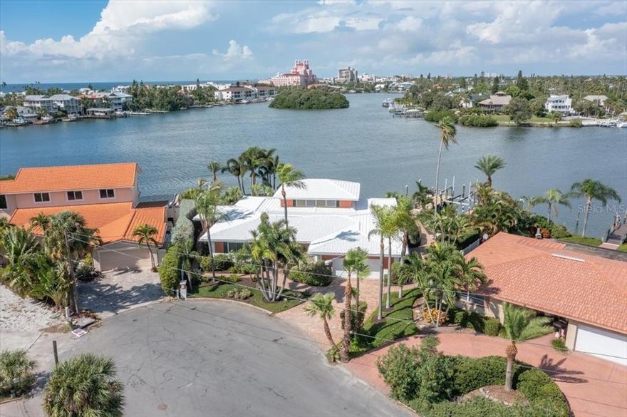 Spectacular waterfront lot on the Island of Vina Del Mar, 160+ ft of waterfront living, a rare find on this gem of an island. Experience Paradise Living and no bridges to the Gulf of Mexico for the avid boater.  The area is one of most sought-after waterfront neighborhoods just off the white sandy beaches of fabulous Pass A Grille and 8th Ave historic district. Located just south of the Don Cesar Hotel. From the street this home deceives then opens up to a waterfront paradise.  Cozy up to the wood burning fireplace on the rare cool nights. Featuring 3 bedroom/3.5 bath. 2 x 4 Evergrain Composite dock, with Deco Concept aluminum 16,000 lb cradle lift, 166ft of seawall installed 2020,  5 ton A/C  2022, gourmet kitchen for entertaining features 2 stoves, 2 microwaves + 2 dishwashers. wet bar with ice maker in serving area.  Paver driveway, walkways, and back patio.  Walk to Vina Del Mar with tennis courts, pickleball + basketball courts, a picnic pavilion with restrooms, dog park with separate areas for small and large breeds. This golf cart friendly community is a few minutes ride to famous Pass A Grille Beach. The community is unique and quaint hidden gem, yet easy access to Major league sports, fine shoppes, parks museums theaters & restaurants. By boat you will enjoy the Gulf of Mexico in less than 10 minutes. By car only 20 minutes to Downtown St Petersburg and 40 minutes to Tampa International airport. Vina del Mar is a wonderful neighborhood with easy access to I-275 and the PERFECT LOCATION to access all this area has to offer! If you've been looking for the perfect waterfront location, then you don't want to miss this tropical paradise! Call for a private showing today.