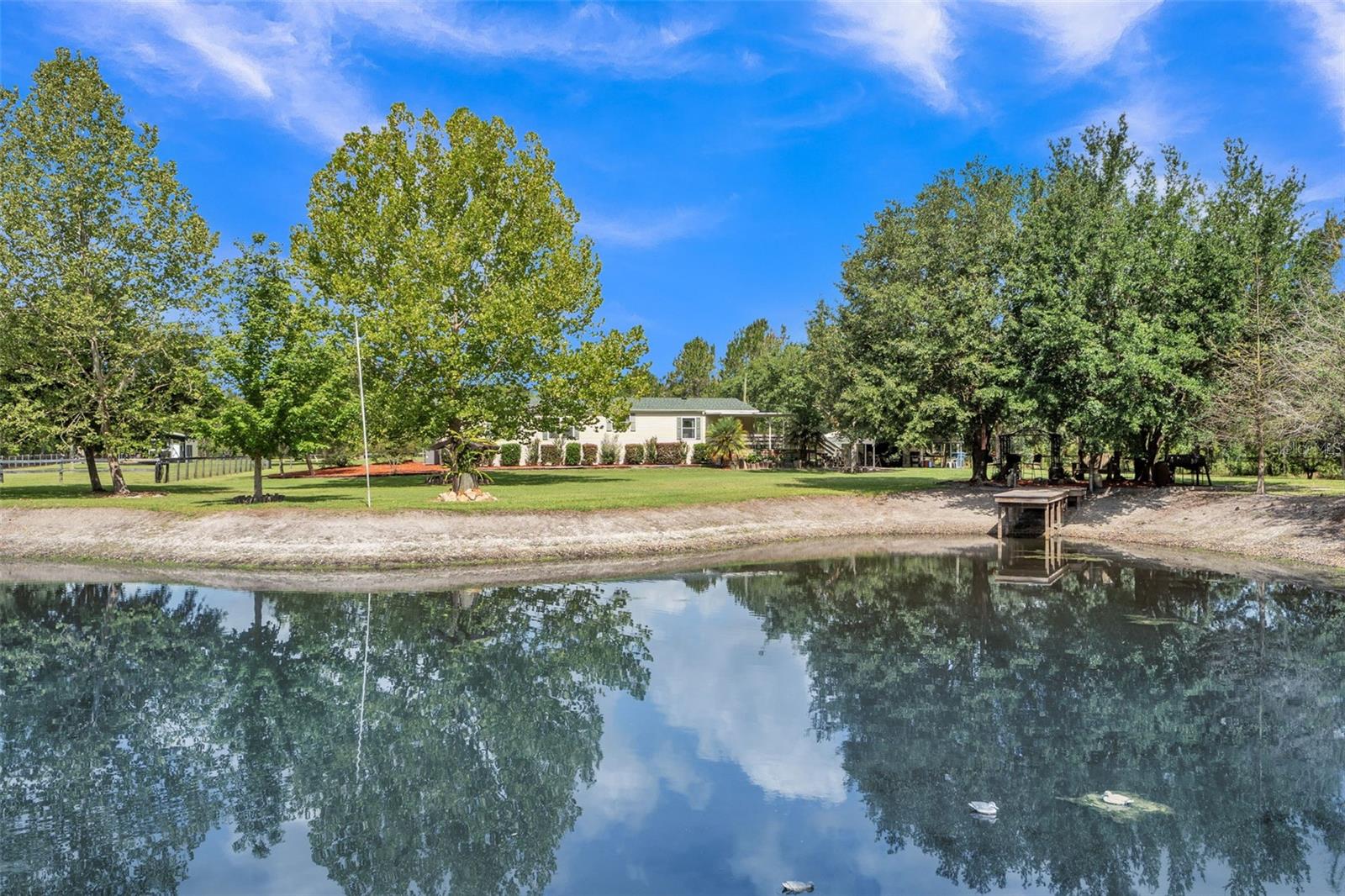 "EXPERIENCE THE BEST OF BOTH WORLDS WITH THIS STUNNING 10-ACRE PROPERTY FEATURING A BARN, WORKSHOP, AND TACK ROOM. YOUR FAMILY WILL LOVE THE PRIVACY OF COUNTRY LIVING WHILE STILL ENJOYING ALL THE CONVENIENCES OF CITY LIFE. RELAX BY THE BEAUTIFUL OUTDOOR FIRE PIT OR UNWIND BY THE SERENE POND-THIS IS THE PERFECT PLACE TO EMBRACETHE GREAT OUTDOORS. DONT MISS OUT ON THIS INCREDIBLE OPPORTUNITY. CENTRALLY LOCATED TO ORLANDO AND DAYTONA AIRPORTS, ACCESS TO HART ISLAND CONSERVATION AND 15 MINUTES AWAY FROM BEAUTIFULL DE LEON SPRINGS.