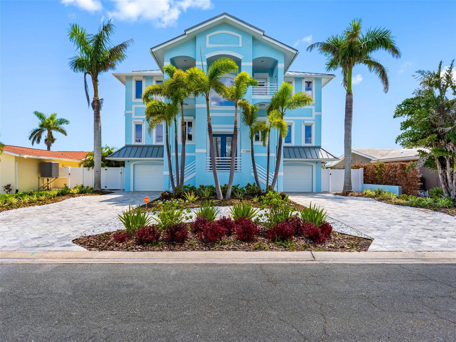 Exceptional Waterfront Retreat with Every Upgrade Imaginable — Treasure Island. This is one you must see in person to fully appreciate. From the moment you arrive, you’ll sense the care and craftsmanship that have gone into every inch of this extraordinary waterfront home. Rarely does a property come to market with such meticulous attention to detail—inside and out. This home gleams and shines everywhere you look. Impeccably landscaped grounds surround a lush backyard oasis anchored by an oversized, covered lanai, newly resurfaced pool, and heated spa. Travertine pavers guide you to your private composite dock, equipped with a 10,000-pound boat lift that holds two jet skis plus a second jet ski lift. With no fixed bridges between you and the Gulf of Mexico, your water-bound adventures—from offshore fishing to dock-and-dine outings—are just minutes away. Facing west, the home offers front-row seats to breathtaking sunsets each evening—enjoy them from your dock, or from one of two expansive, covered balconies. Step inside to find panoramic water views that immediately draw the eye. The open-concept main level is ideal for entertaining, featuring a massive chef’s kitchen that flows seamlessly into the light-filled living and dining areas. Two bedrooms and a spacious laundry room complete this level. Upstairs, the private primary suite is your personal sanctuary, complete with two walk-in closets, a spa-like ensuite bath, and access to a wide balcony overlooking the Intracoastal—perfect for peaceful mornings with coffee in hand. Two additional oversized bedrooms, each with their own ensuite baths and walk-in closets, round out the upper level. Additional highlights include: a brand new metal roof, hurricane-impact windows and storm shutters, a whole-house sprinkler system, an elevator servicing all three floors, Hardie board interior construction on the lower level, three-car garage plus a bonus room overlooking the lanai -- just for starters. This home truly has more square footage and amenities than any comparable property on the beaches. Located in the heart of friendly, vibrant Treasure Island—famous for its wide sandy beaches, beach festivals, local seafood restaurants, and laid-back charm—you’ll quickly see why island life here is something special. Kick off your shoes. You’ve found your paradise.