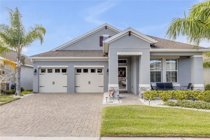 Welcome to 206 Venetian Palms Blvd, where thoughtful design meets modern comfort in one of New Smyrna Beach’s most sought-after communities. Ideally located for commuters heading toward Orlando or anyone craving a quick drive to our beloved beach, this 2019-built home stands out with extensive upgrades and low-maintenance living.  A charming covered front porch invites you inside, where wood-grain ceramic plank tile flows seamlessly through the main living areas and primary suite. The open-concept floor plan makes entertaining effortless—from the gourmet kitchen featuring 42" cabinetry, quartz countertops, an island, and a stylish quatrefoil backsplash, to the dining area, living room, and Florida Room overlooking a tranquil pond. Step outside to the extended paver patio, perfect for relaxing or hosting friends.  Upgraded plantation shutters complement hurricane-rated windows, offering both style and peace of mind. Each bathroom has been finished with custom tile showers—one with a tub/shower combo and two with walk-in showers, including a handicap-accessible design. The primary suite impresses with tray ceilings, two walk-in closets, and a linen closet for extra storage.  Additional features include a laundry room at the center of the home for convenience and an oversized split 3-car garage, with one tandem bay equipped with ceiling-mounted storage racks supporting up to 600 lbs each. Paver walkways have been thoughtfully expanded for handicap accessibility, and the landscaping is low maintenance, giving you more time to enjoy the Florida lifestyle.
This move-in-ready home truly shines among the rest—schedule your private showing today and discover why life at The Palms is easy living done right.