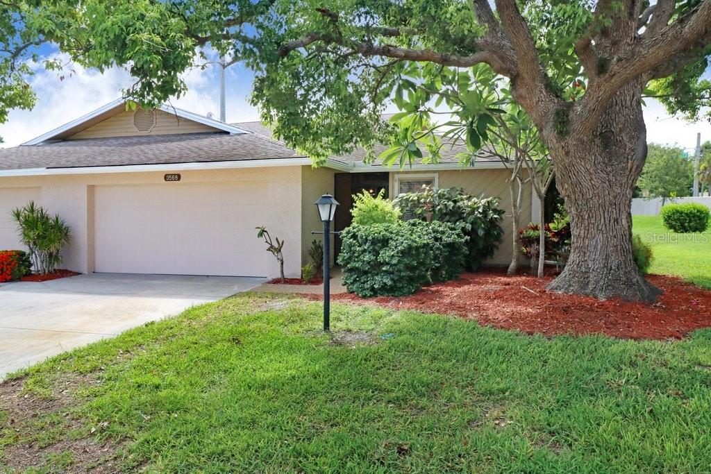 Welcome to this stunningly remodeled 3-bedroom, 2-bathroom villa nestled in the desirable Wilkinson Woods community. Step inside to discover a bright and open living space, seamlessly combining the dining and living areas. The living room features a charming brick wood-burning fireplace, perfect for cozy evenings. Large sliding doors lead out to a spacious enclosed back patio, ideal for outdoor entertaining and relaxation.
The modern kitchen is a chef’s dream, boasting quartz countertops, a stylish subway tile backsplash, stainless steel appliances, and ample cabinet storage. The generous master suite offers access to the back patio and includes an en-suite bathroom with oversized quartz countertops and a stand-alone shower, creating a luxurious retreat.
Additional highlights include two comfortable guest bedrooms, a well-appointed guest bathroom, durable laminate flooring throughout the living areas and bedrooms, fresh paint, a convenient laundry room, and a two-car garage. The backyard provides plenty of space for outdoor activities and gatherings, making this villa a perfect blend of comfort and style. Don’t miss the opportunity to make this beautifully updated home yours!