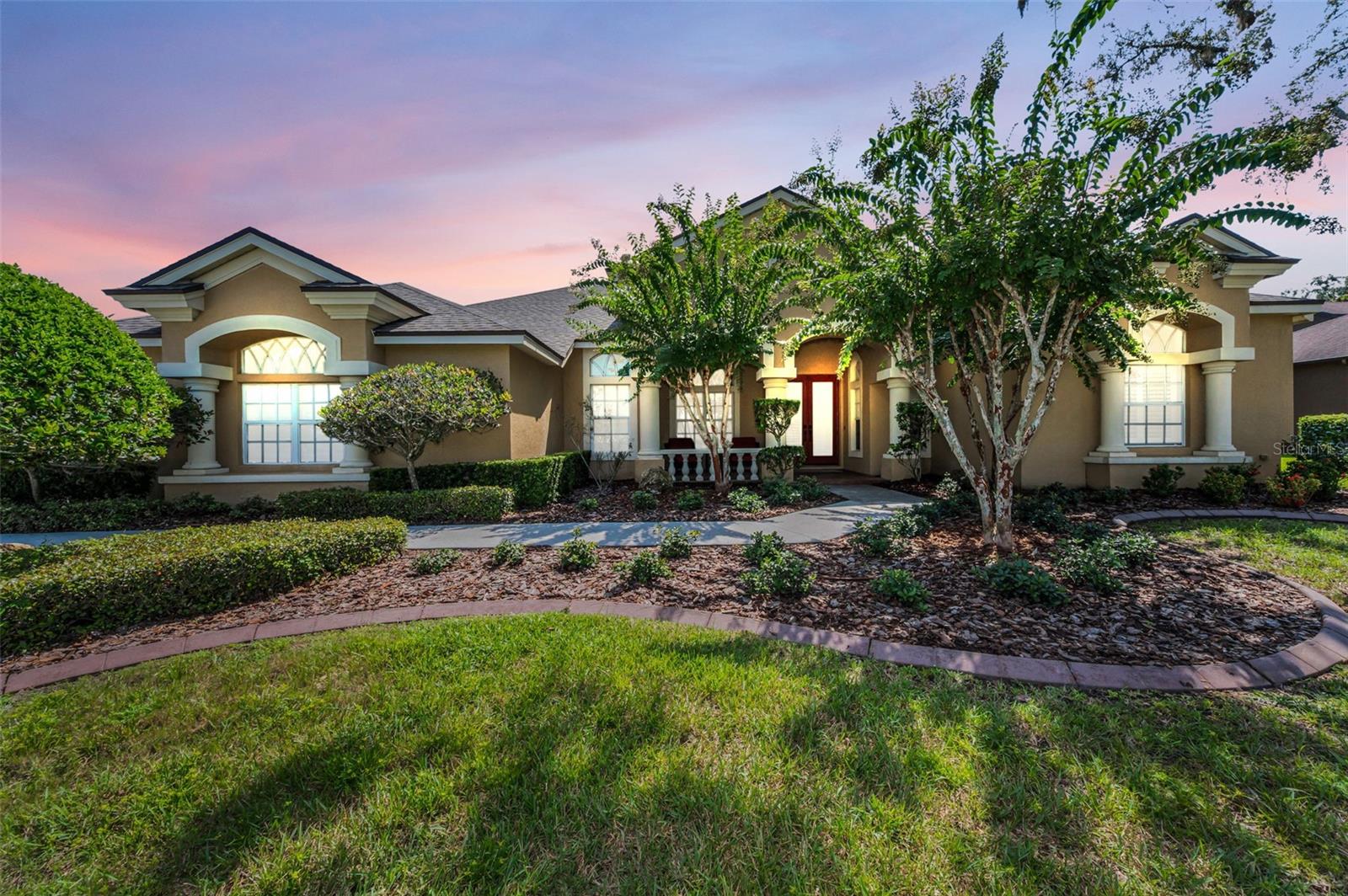 BEAUTIFUL GREY HAWK AT LAKE POLO HOME. QUALITY & CHARACTER ABOUND IN THIS PRISTINE HOME AND IT TRULY SHOWS LIKE A MODEL. SPACIOUS 4BR, 3 BATH HOME WITH A LARGE BONUS ROOM WHICH COULD BE A GUEST SUITE OR IN-LAW W/SEPARATE, OUTSIDE ENTRY. THERE IS AN OVERSIZE THREE CAR SIDE-ENTRY GARAGE. SPARKLING SCREEN POOL WITH DECORATIVE STONE WATERFALL FOR A VERY RELAXING VIEW. THE CHARMING COVERED FRONT PORCH W/BRICK PAVERS, GLASS DOUBLE DOORS AND GLEAMING HARDWOOD FLOORING IN THE ENTRY, LR, DR, FR & KIT PROVIDES AN ELEGANT ENTRY TO YOUR FORMAL AREAS. THE LR HAS A TREY CEILING, W/DOUBLE GLASS FRENCH DOORS TO THE LANAI. THE KITCHEN IS DELIGHTFUL, W/BEAUTIFUL GRANITE COUNTERTOPS, NEW STOVE & MICROWAVE (AUGUST 2025), AN ABUNDANCE OF WOOD CABINETS AND A LARGE BREAKFAST BAR FOR ADDITIONAL SEATING. THE KITCHEN IS OPEN TO THE FR AND EATING AREA WITH MITERED GLASS WINDOW THAT PROVIDES A PICTURESQUE VIEW OF THE POOL AND WATERFALL. THE MITERED WINDOW HAS A CUSTOM VALANCE WITH RETRACTABLE SHADES. THERE IS ALSO A SINGLE GLASS FRENCH DOOR LEADING TO THE COVERED/SCREENED LANAI. THE FR HAS A BEAUTIFUL CATHEDRAL CEILING, WOOD BURNING FIREPLACE WITH A LOVELY MANTLE AND DECORATIVE NICHE. THE FANTASTIC BONUS ROOM HAS TRIPLE SLIDING GLASS DOORS, WITH RETRACTABLE SHADES, THAT LEAD TO THE LANAI/POOL AND DOUBLE FRENCH DOORS TO THE FR. ALL BATHS HAVE TILE FLOORS (TILE GROUT WORK AND CALKING IN ALL BATHS AND LAUNDRY WAS COMPLETED/UPDATED (MARCH 2025). WHILE THE BEDROOMS AND BONUS ROOM HAVE NEW CARPET (MARCH 2025). THE HOME ALSO HAS MULTIPLE SETS OF PLANTATION SHUTTERS AND CUSTOM VALANCES. ALSO 2 NEW A/C UNITS (COMPRESSOR & AIR HANDLER (JULY 2023), WROUGHT IRON FENCED BACK YARD WITH NEWLY INSTALLED PRIVACY LANDSCAPING (MARCH 2025). NEW ROOF (JULY, 2024). NEW HOT WATER HEATER (MARCH 2025). NEW EXTERIOR PATIO FANS AND NEW EXTERIOR DOOR NOBS (2025). THERE IS NO CDD. THERE IS A ONE-TIME CAPITAL CONTRIBUTION TO THE HOA FOR NEW RESIDENTS OF $3,000. THE COMMUNITY ALSO HAS A PLAYGROUND, TENNIS COUNTS, BASKETBALL COURT, BEACH VOLLEYBALL, FISHING PIER AND WALKING TRAILS.