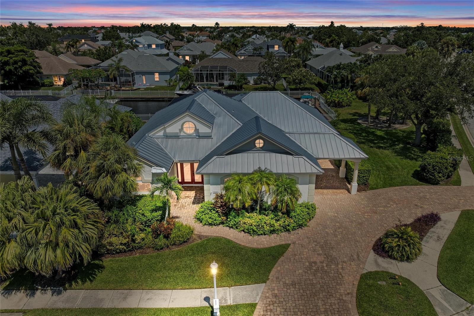 Exquisite home in Riverdale/The Inlets! This fully updated 4 bedroom, 3 bath home sits on a generous corner lot and offers privacy, space and curb appeal with direct access to a boatable canal—perfect for boating enthusiasts and water lovers alike. Some of the features include an open kitchen with custom, handmade cabinetry, granite countertops, upgraded appliances including a Wolf gas range, double convection oven, a built- in subzero wine cooler and a tankless hot water heater. The home has all new impact windows and doors and a NEW metal roof that is durable & stylish, ensuring peace of mind for years to come. Roof, windows, doors and kitchen cabinets all have transferable warranties. The expansive pool and patio area boasts travertine pavers throughout the outdoor living space and a panoramic pool screen that offers unobstructed, sweeping views of the canal that you can enjoy while swimming or lounging. The covered area of the patio is equipped with a motorized screen system, transforming the space into a true outdoor living room - keeping it cool, shaded and bug free at the touch of a button. This community is centrally located, offering easy access to Interstate 75, shopping, restaurants and medical facilities. This home blends luxury, functionality and the ultimate Florida waterfront lifestyle and is nestled in one of Bradenton’s most well-known waterfront communities, offering both prestige and convenience. You are not going to want to miss this one - schedule an exclusive showing appointment TODAY!