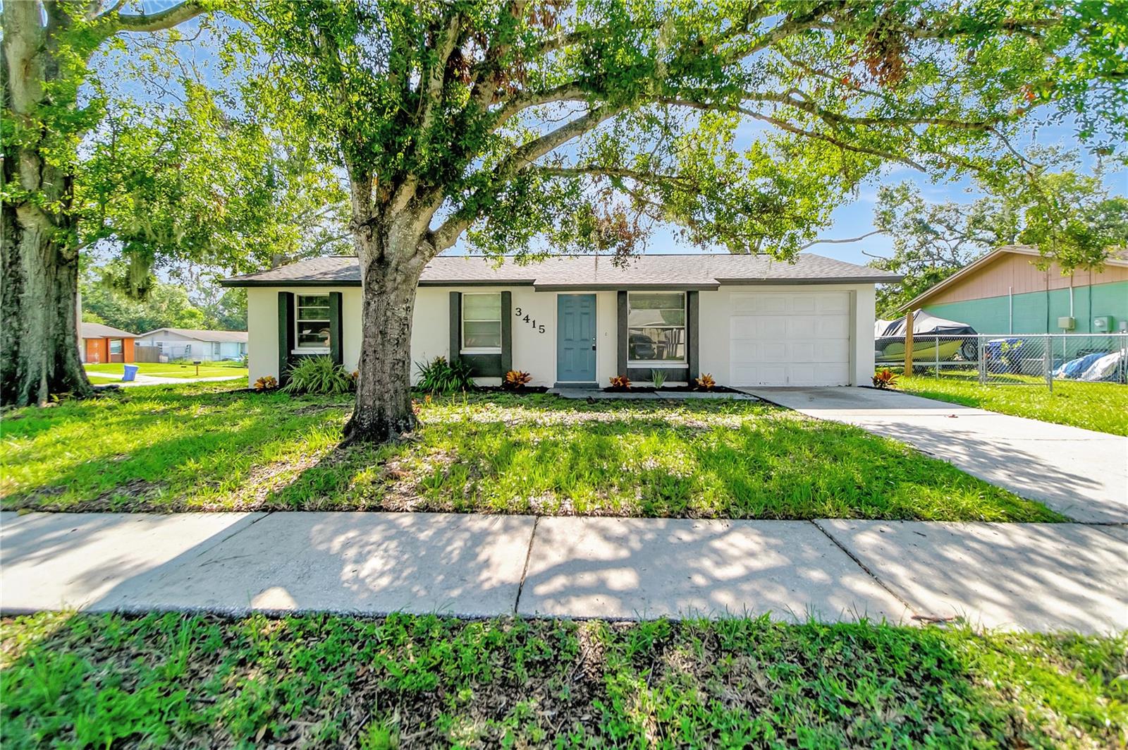 TASTEFULLY UPDATED DREAM HOME! Open floor plan, many NEW updates!! NEW ROOF IN 2023! Fresh Paint inside and out!! The cook in your house will appreciate the large kitchen featuring appliance package, and all wood cabinets with custom countertops. The large open floor plan makes this home great for entertaining. New life lock waterproof flooring through out. Bathroom has been fully updated with new vanity, updated lighting and plumbing fixtures as well as custom tile shower surround. Great curb appeal and beautiful interior make this home move in ready! Large corner lot makes this home perfect for entertaining. Low Taxes and No HOA make this an affordable option! This home has all you need for that laid-back Florida lifestyle.