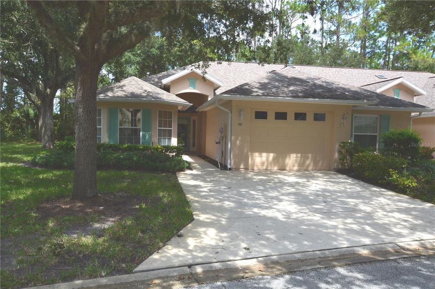 Savannah Square Serenity. Step into this charming 2 bed, 2 bath end-unit townhome nestled between 4 mature Oak Trees in the quiet, tree-lined streets of Savannah Square—where peaceful living meets everyday convenience. Prime Location just minutes from the vibrant center of Palm Coast, enjoy effortless access to shopping, dining, entertainment, nature parks, medical centers, and more. Your private retreat awaits with a spacious primary bedroom, complete with a walk-in closet and walk-in shower for ultimate comfort. Backyard Bliss. Start your mornings with coffee and calm—your backyard overlooks beautiful trees and a tranquil freshwater canal, offering a daily dose of nature. All-Inclusive HOA Perks. Enjoy stress-free living with a small HOA fee of $420 monthly coverage that includes roof, trash, cable, internet, exterior maintenance, termite treatment, plus access to the community pool and clubhouse. End Unit Advantage - This desirable unit offers added privacy, extra natural light and a more spacious feel. Lifestyle Extras. As a resident, you'll also enjoy access to the nearby Pine Lakes Country Club—featuring an Arnold Palmer 18- hole golf course, swimming, dining, and meeting facilities that elevate your leisure time. Florida Room (135 sq ft) enclosed with windows on two sides but not included in square footage. Recent Updates: Roof replaced in 2019, A/C replaced in 2025. This unit is priced to sell!