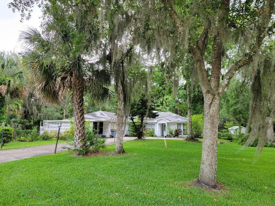 Concrete block family home with split bedroom and open floor plan with vaulted ceiling in living area. Country feeling, with lots of trees, but close to town. Nice pond at rear of home makes for a tranquil setting to enjoy the outdoors from covered patio, as well as spacious screen  porch. Plenty of elbow room on this flexible parcel, that possibly may allow for 2 lots to be broken off and sold, on the west side of the pond. ;Water: City