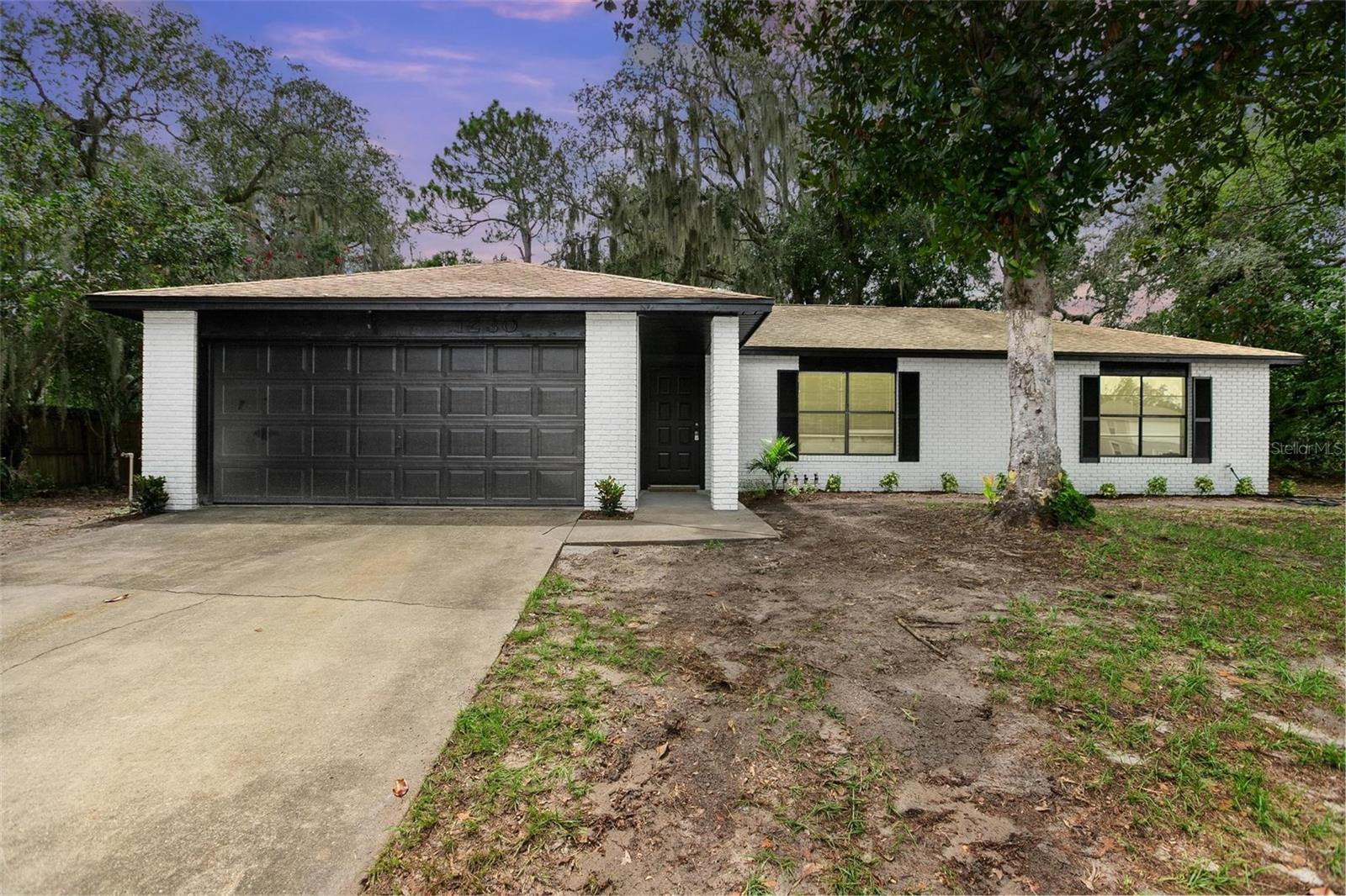 Welcome to this beautifully remodeled 3-bedroom, 2-bath home located in the desirable Deltona Lakes community. From the moment you arrive, you'll notice the fresh exterior paint, new landscaping, and a re-screened rear patio that add to the home's curb appeal and outdoor enjoyment. Step inside to discover a bright, modern interior featuring brand-new luxury vinyl plank flooring, updated baseboards and trim, and freshly painted walls throughout using high-quality Sherwin-Williams paint. The kitchen is a true showstopper with all-new soft-close cabinetry, granite countertops, updated plumbing, new faucets, disposal, and stylish lighting. The living room offers a cozy fireplace and an open view from the kitchen, creating the perfect space for entertaining or relaxing with family. Both bathrooms have been fully updated, with the master bath showcasing beautiful new tile, granite vanity, and new plumbing fixtures. Additional upgrades include new ceiling fans, lighting fixtures, and electrical devices throughout the home, as well as a newer A/C system for year-round comfort. Outside, enjoy the screened-in rear patio overlooking a spacious backyard complete with a large storage shed for all your tools and toys. This turnkey home is move-in ready and perfectly located near schools, parks, shopping. Don’t miss your chance to own this stunning, fully updated home in the heart of Deltona Lakes.